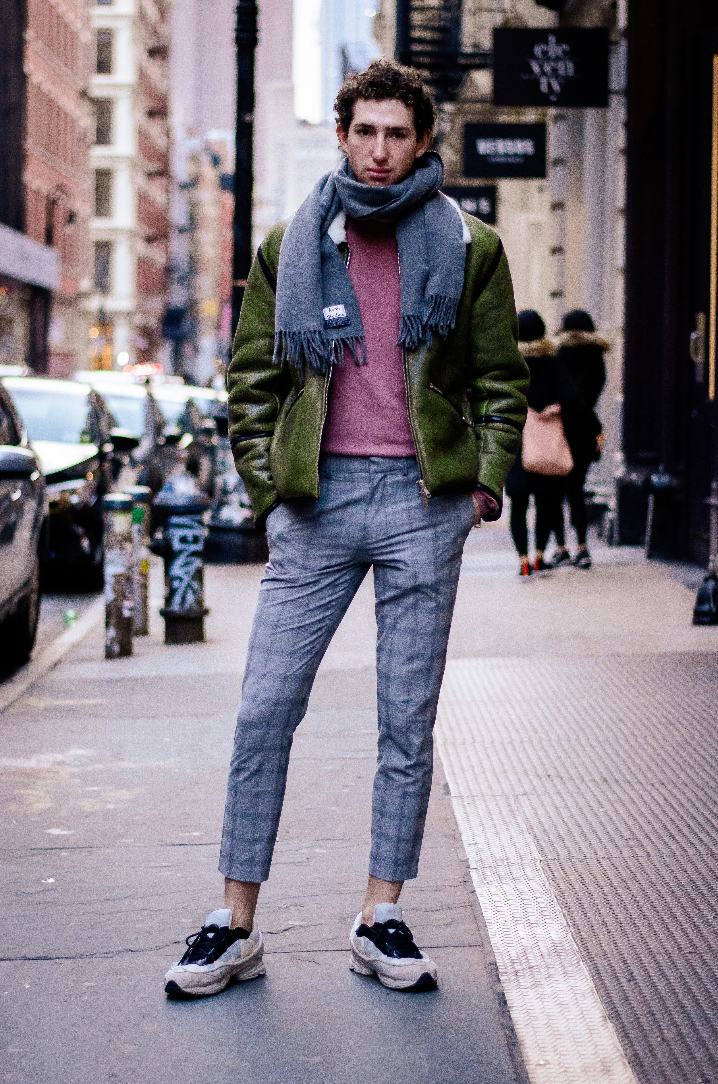 Deep nostalgia for temperate days: His winter outfit features warm-coloured pieces such as his green shearling jacket, and blush-red sweatshirt. Also, given the frigid temperatures, he bravely ditched the socks. The resulting combination of ankle exposure, plaid pants, and Raf Simons sneakers is a style move worth stealing.