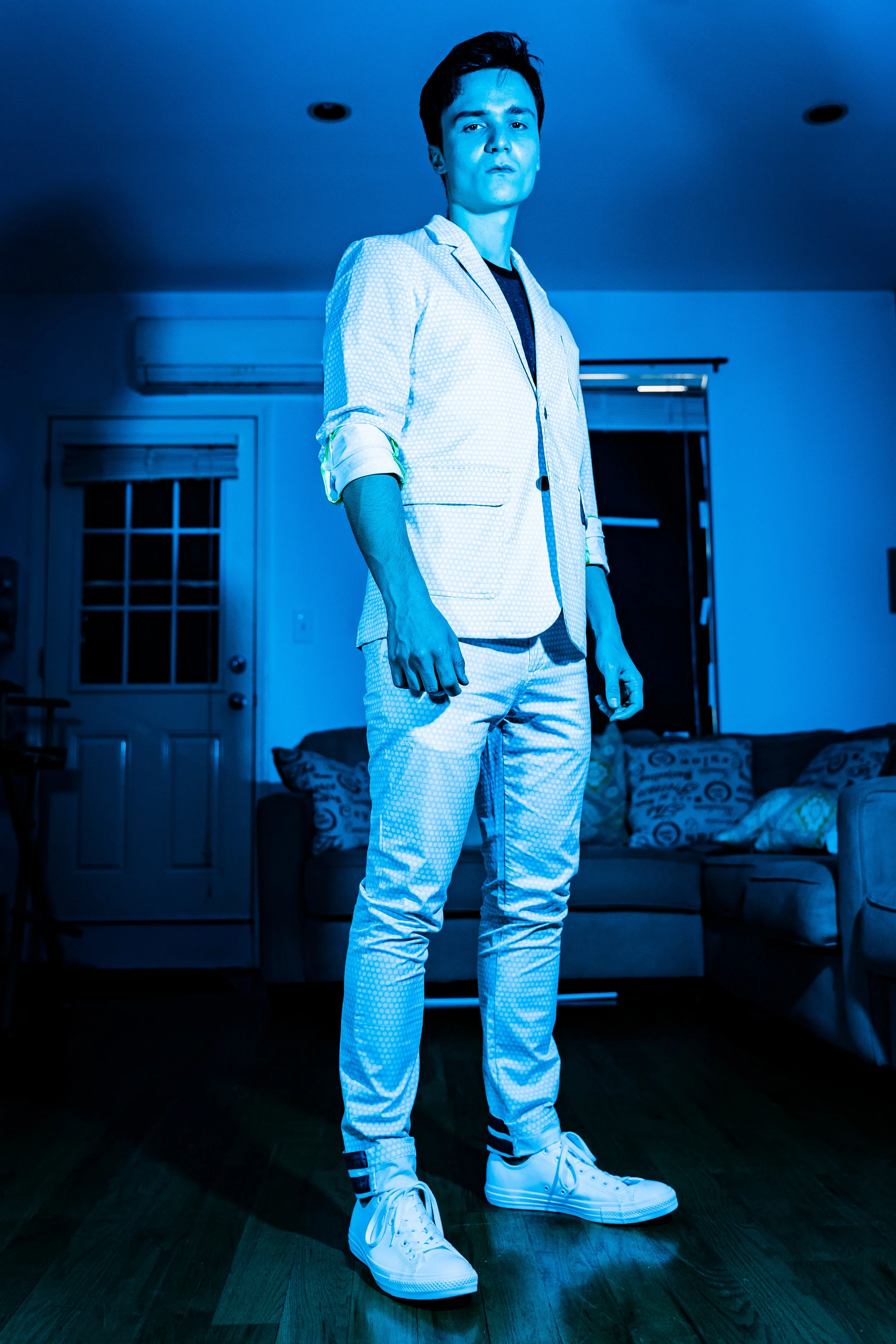 Rarely does one cuff the pants of a subtle-polka dot white suit to reveal cheeky ankle details.