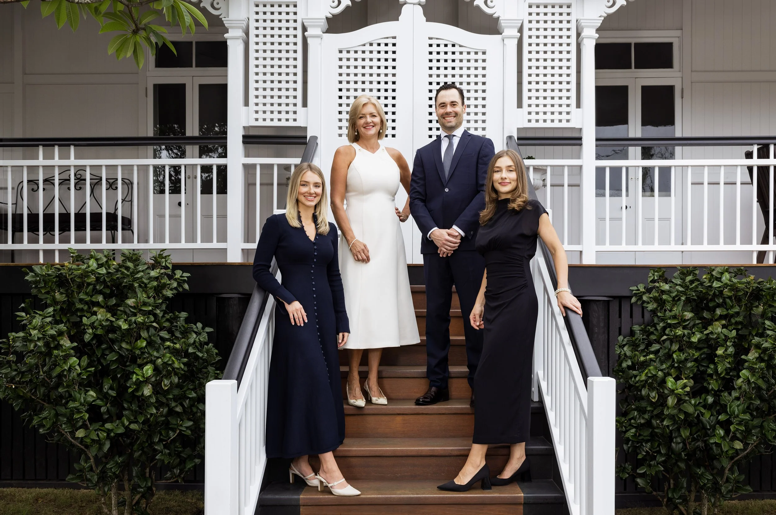 Righton Property real estate team headshots in front of a Queenslander home, Ashgrove Brisbane