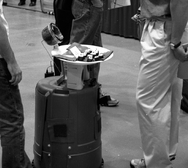 Just so future generations know, this is also what another robo-butler looked like in 2001. A headlamp tethered to a garbage bin and a plate of sushi held up by a smattering of discarded cell phone boxes and a kiddie hockey stick. It was a quaint, simpler time.