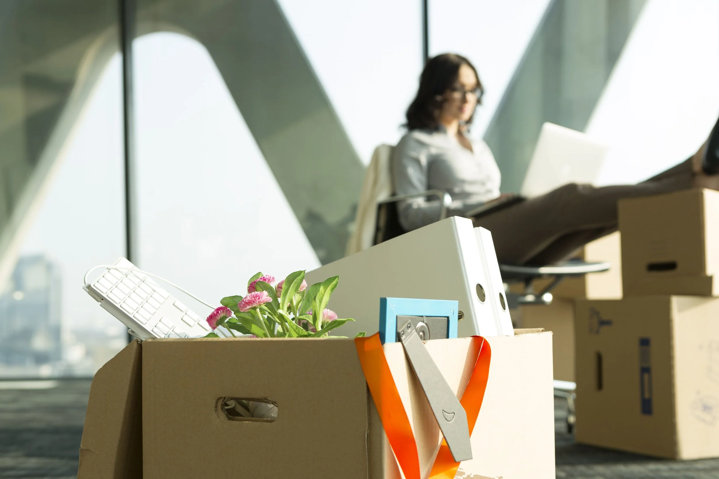 cardboard-box-on-office-floor-with-businesswoman-in-background-515028213-5bc0e52446e0fb002613771a.jpg