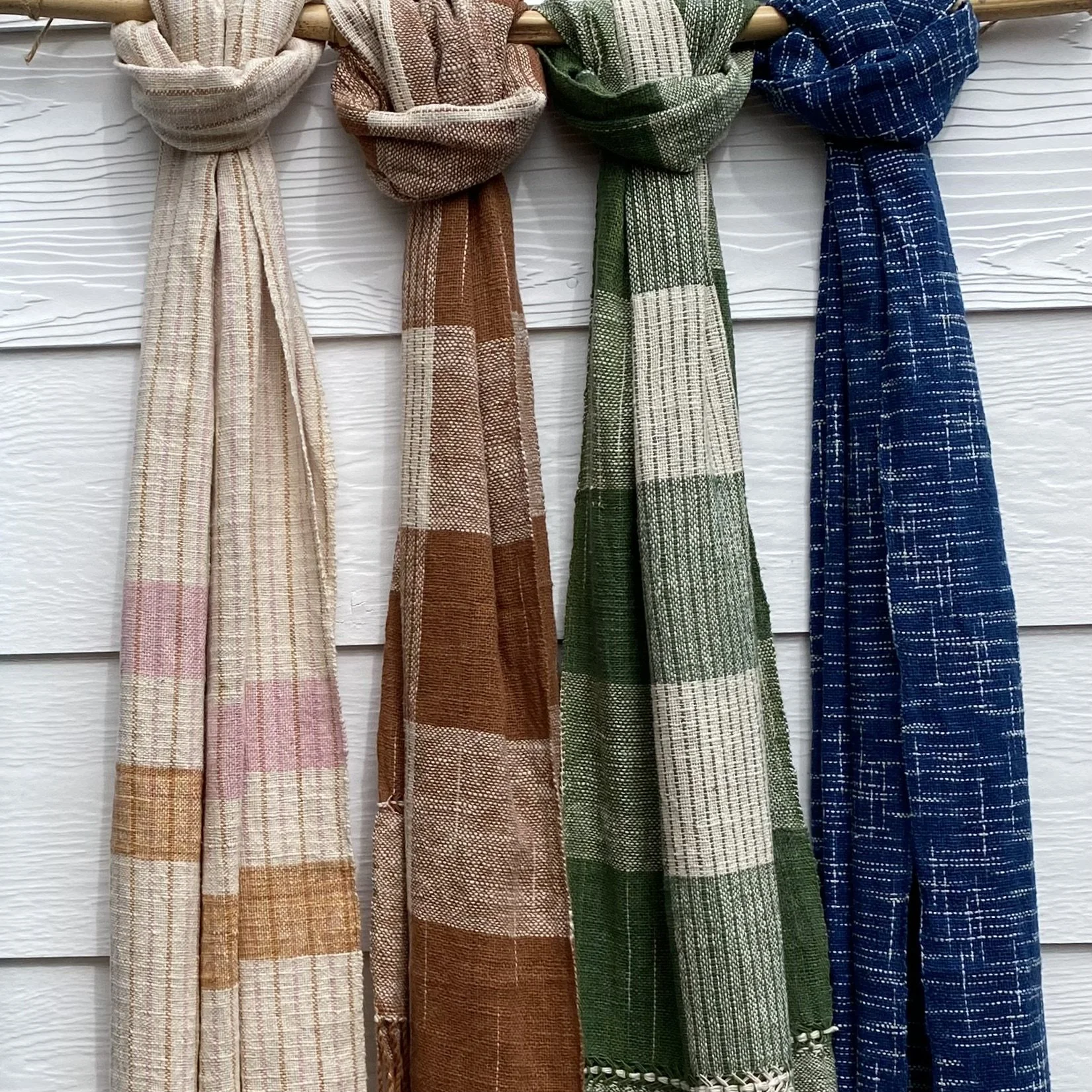 LOOM Designs Lao Cotton Scarves hanging on white weatherboard wall.jpeg