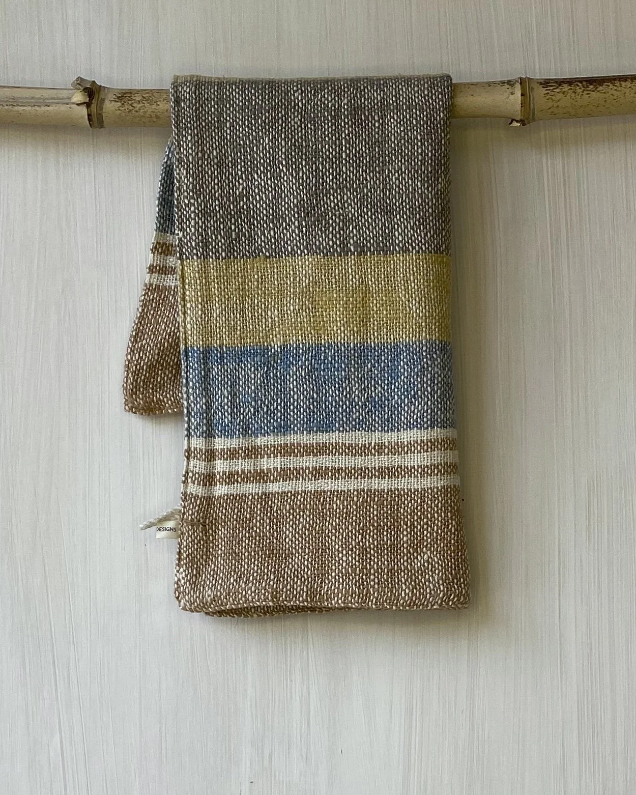 Hand Towel Retro Indigo Marigold, Cinnamon Stripe hanging folded in half on rod Loom Designs.jpg