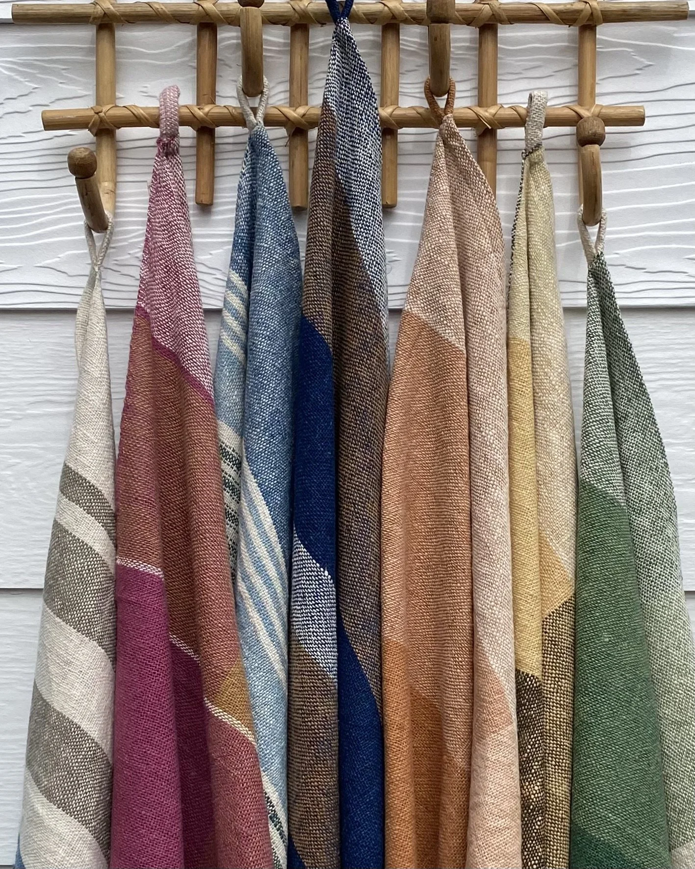 LOOM Designs our collection of Tea Towels on weatherboard wall.jpeg