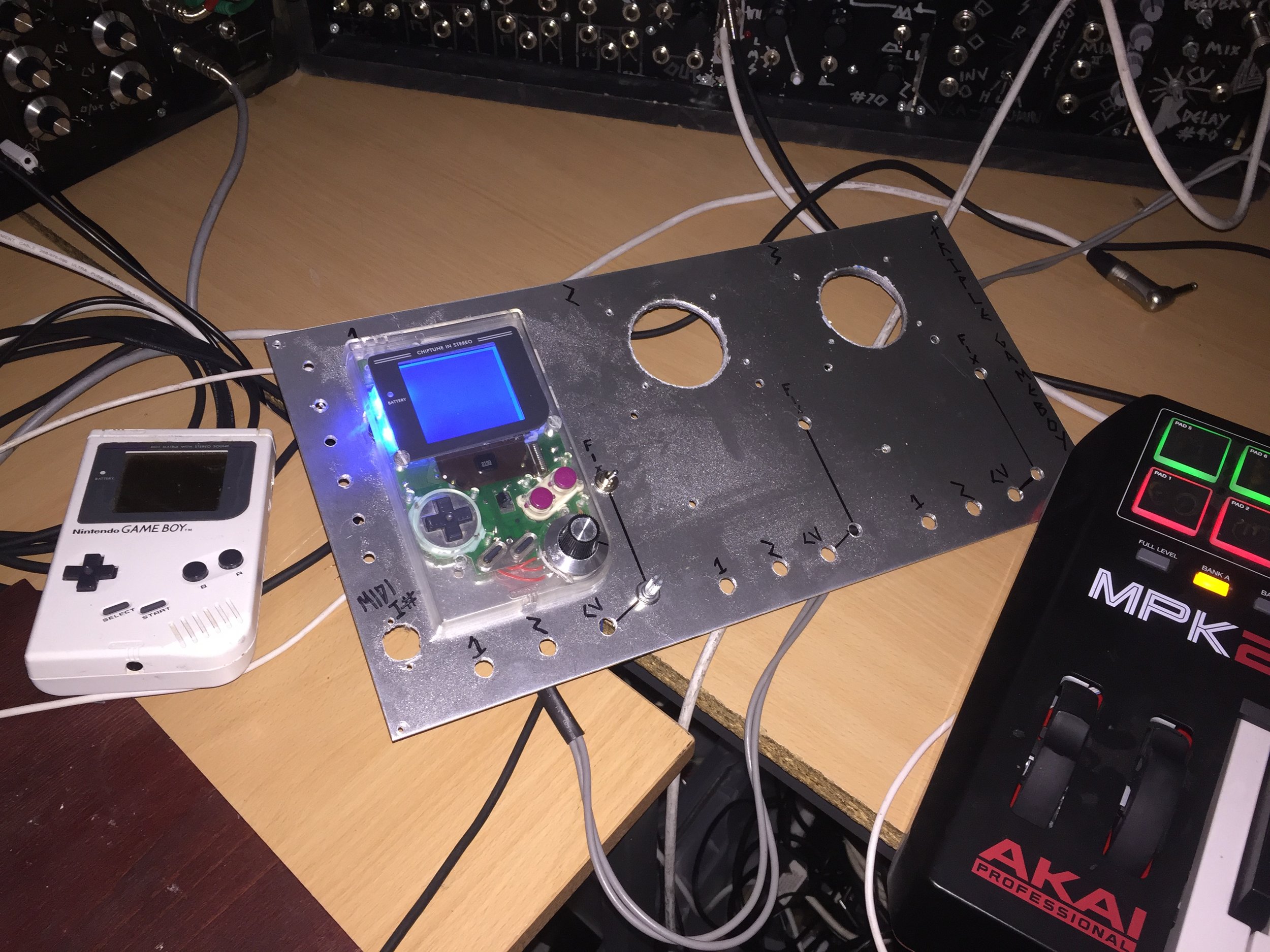 The gameboys are mounted with the backs on standoffs behind the panels and the fronts bolted to the front. with all supporting circuitry in and around them.