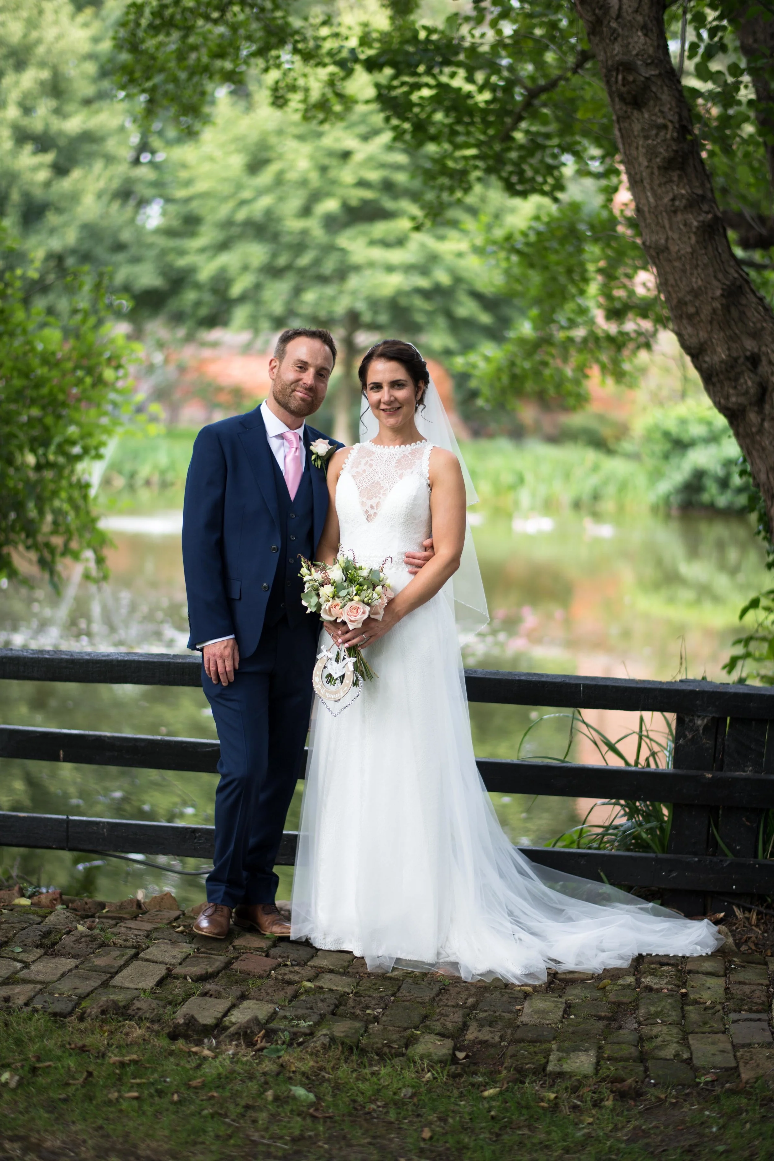 Happy couple by the lake at Leez Priory, Essex