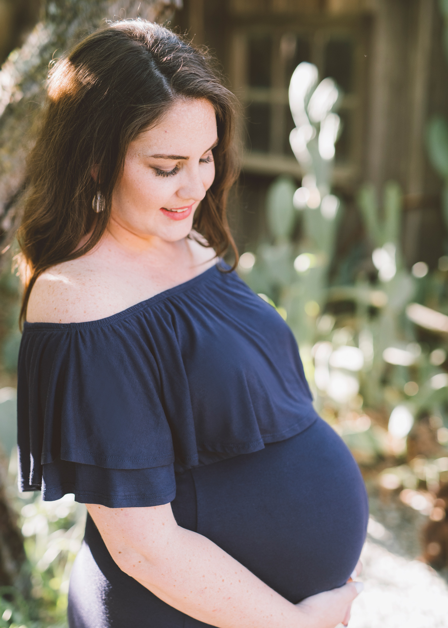 pregnant-woman-gazing-towards-her-growing-belly.jpg