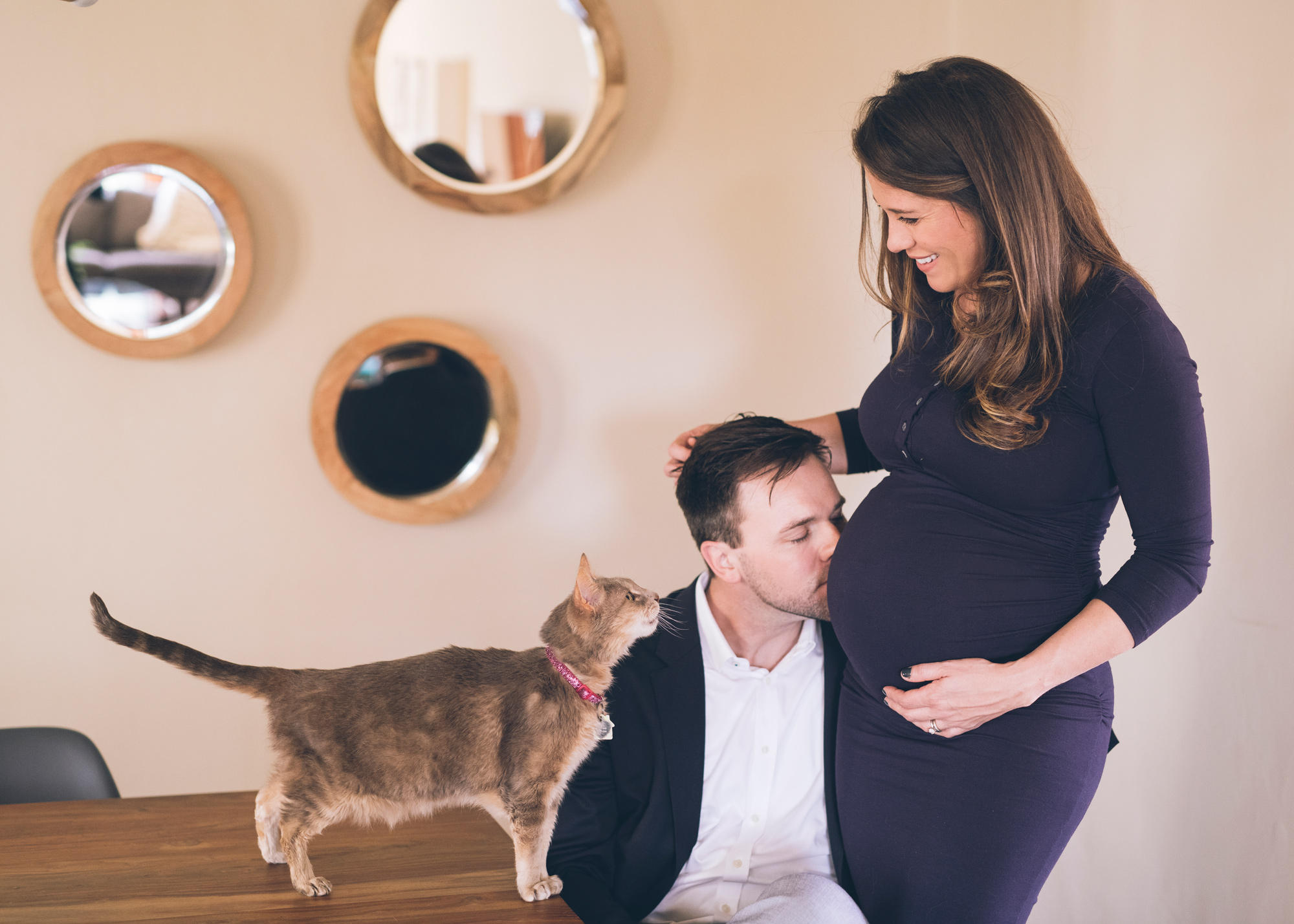 husband-is-kissing-his-pregnant-wife-belly-with-a-cat.jpg