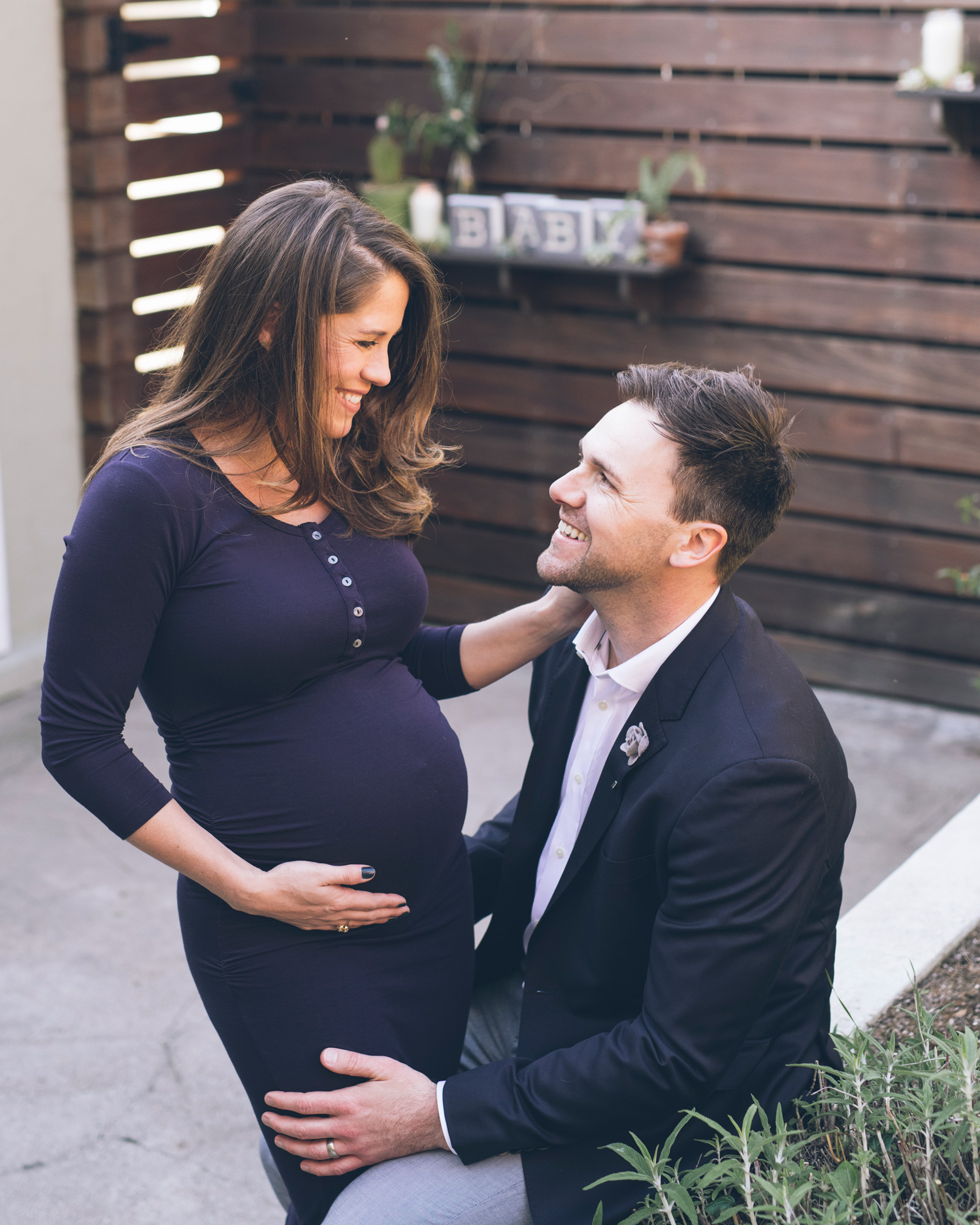 expectant-couple-smiling-at-each-other.jpg