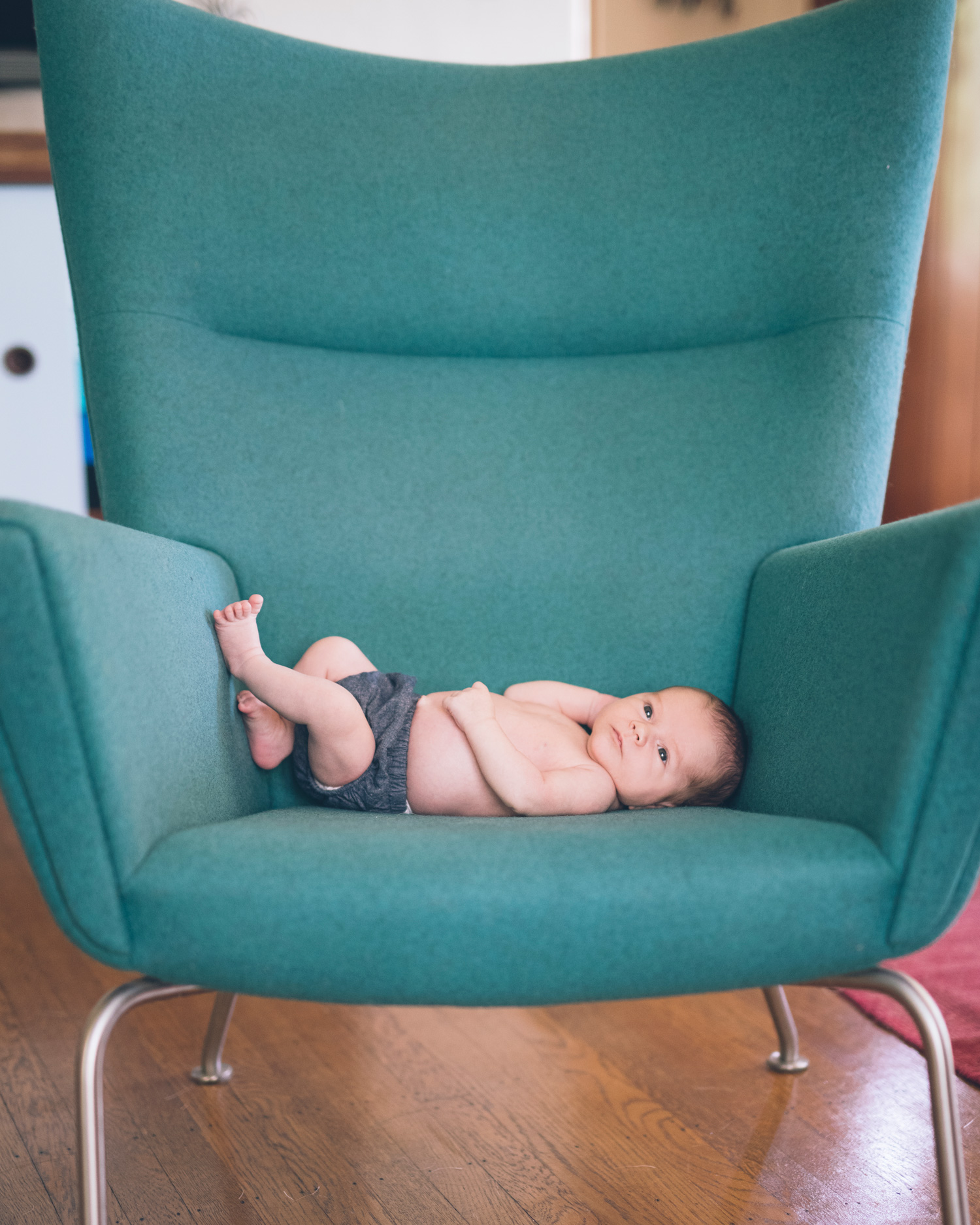 newborn-baby-boy-on-a-mid-century-modern-green-chair.jpg