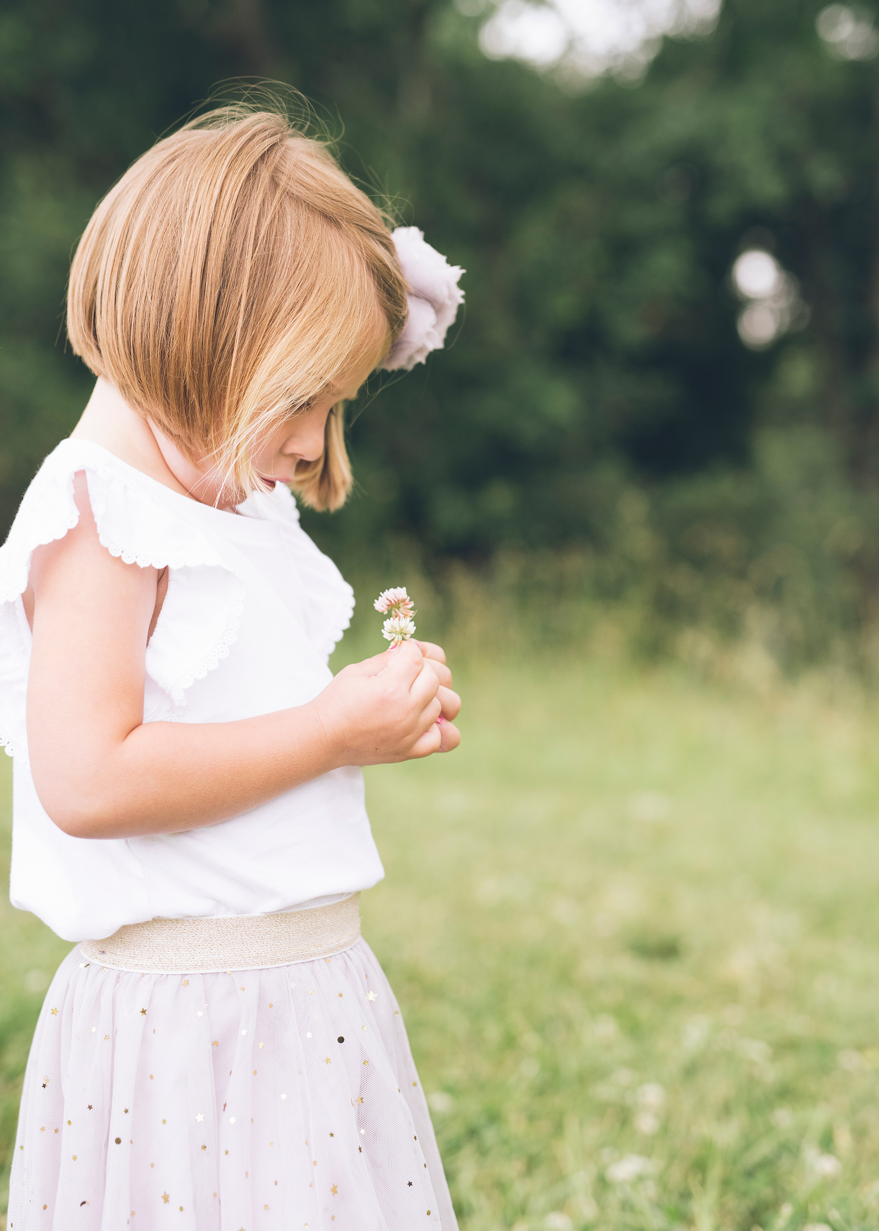 four-year-old-girl-looking-at-the-flower.jpg