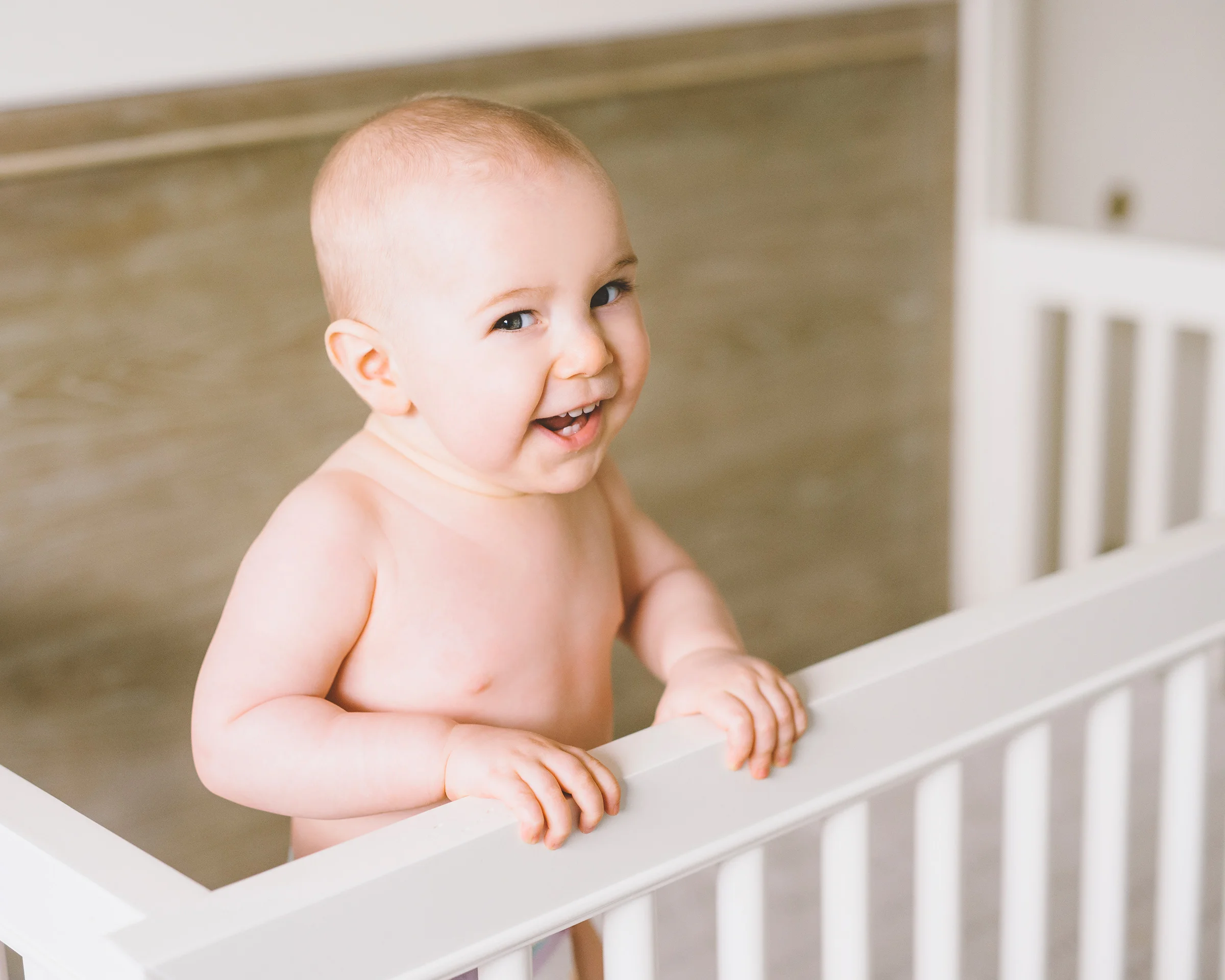 baby-boy-smiling-in-the-crib.jpg