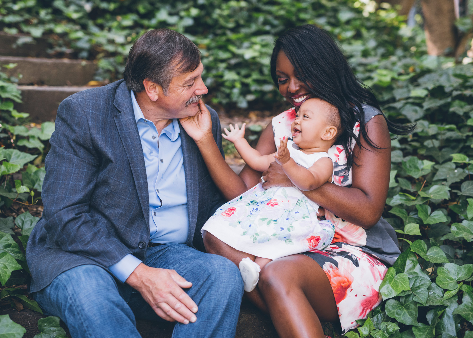 fahter,-mother-and-baby-daughter-sitting-on-wooden-steps-at-the-berkeley-rose-garden.jpg