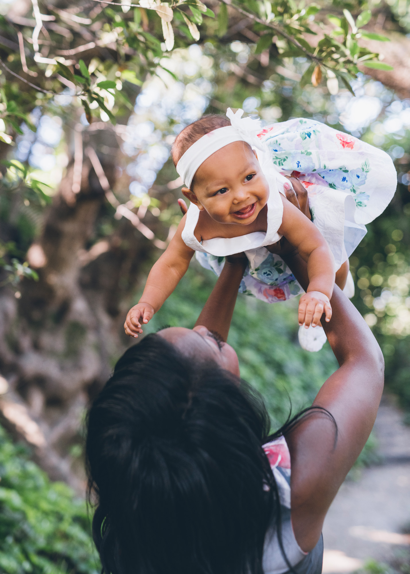 mother-holding-her-cute-baby-daughter-up-in-the-air.jpg