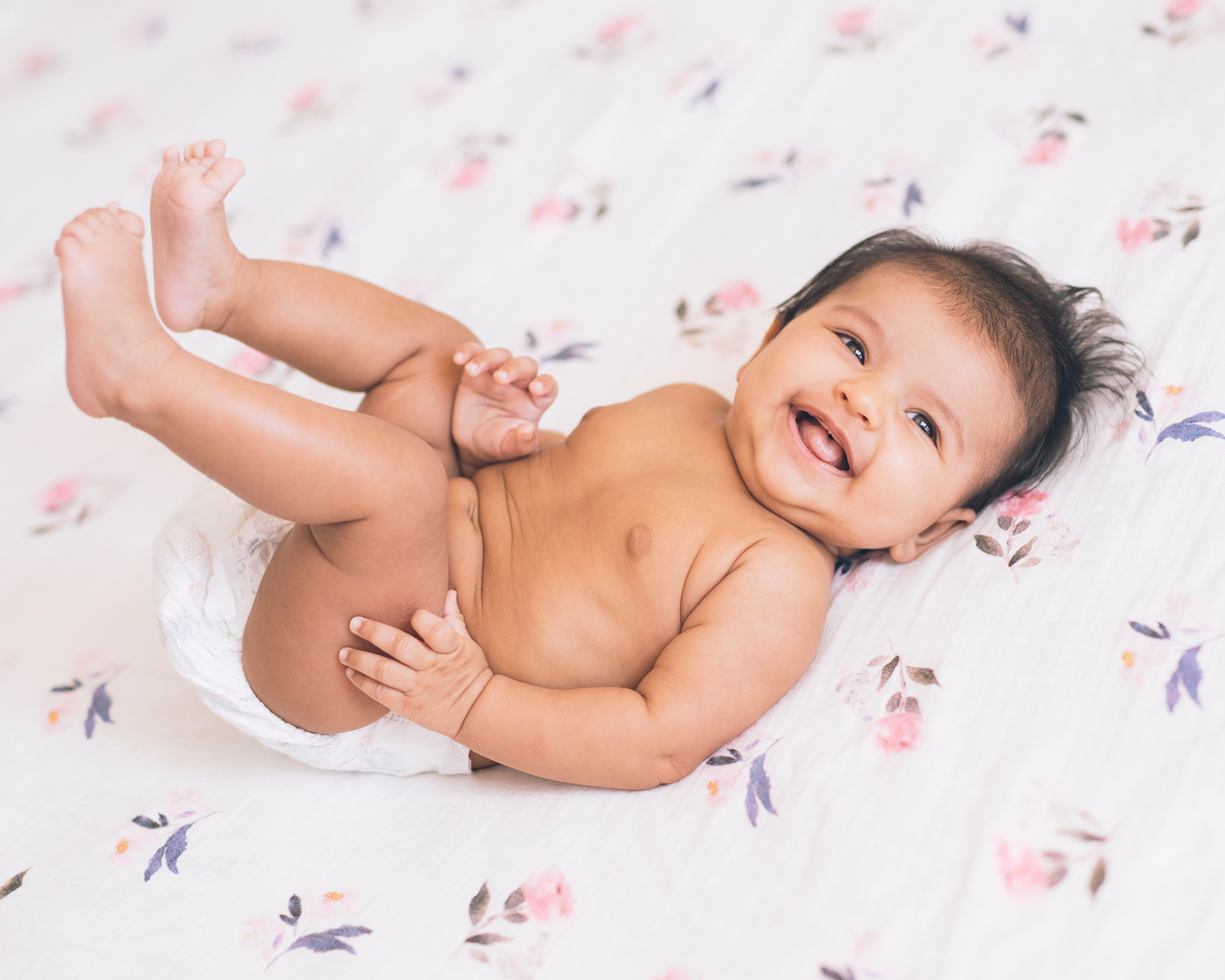 three-month-old-baby-girl-smiling-in-her-crib.jpg