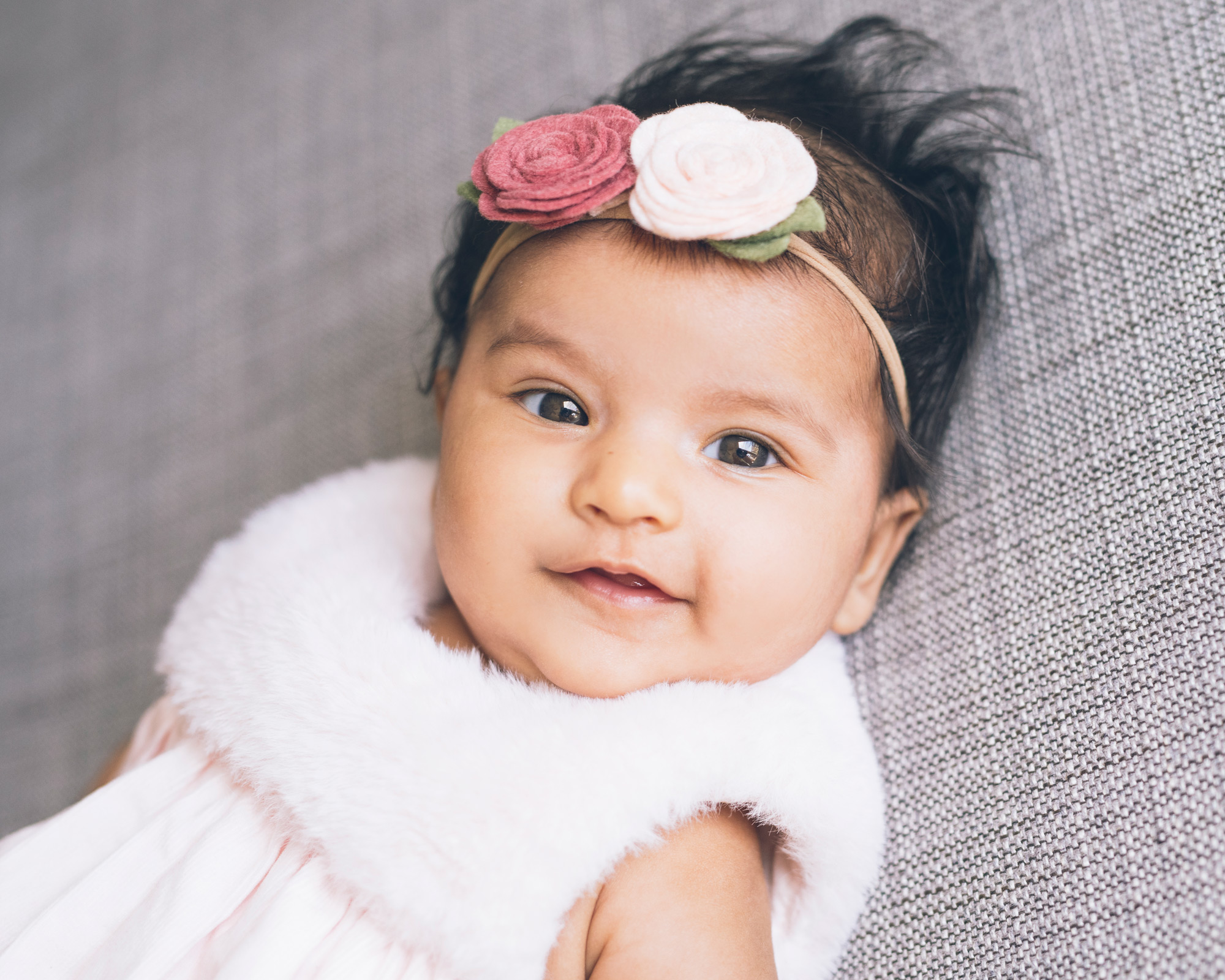 baby-girl-with-flower-headband-looking-at-the-camera.jpg