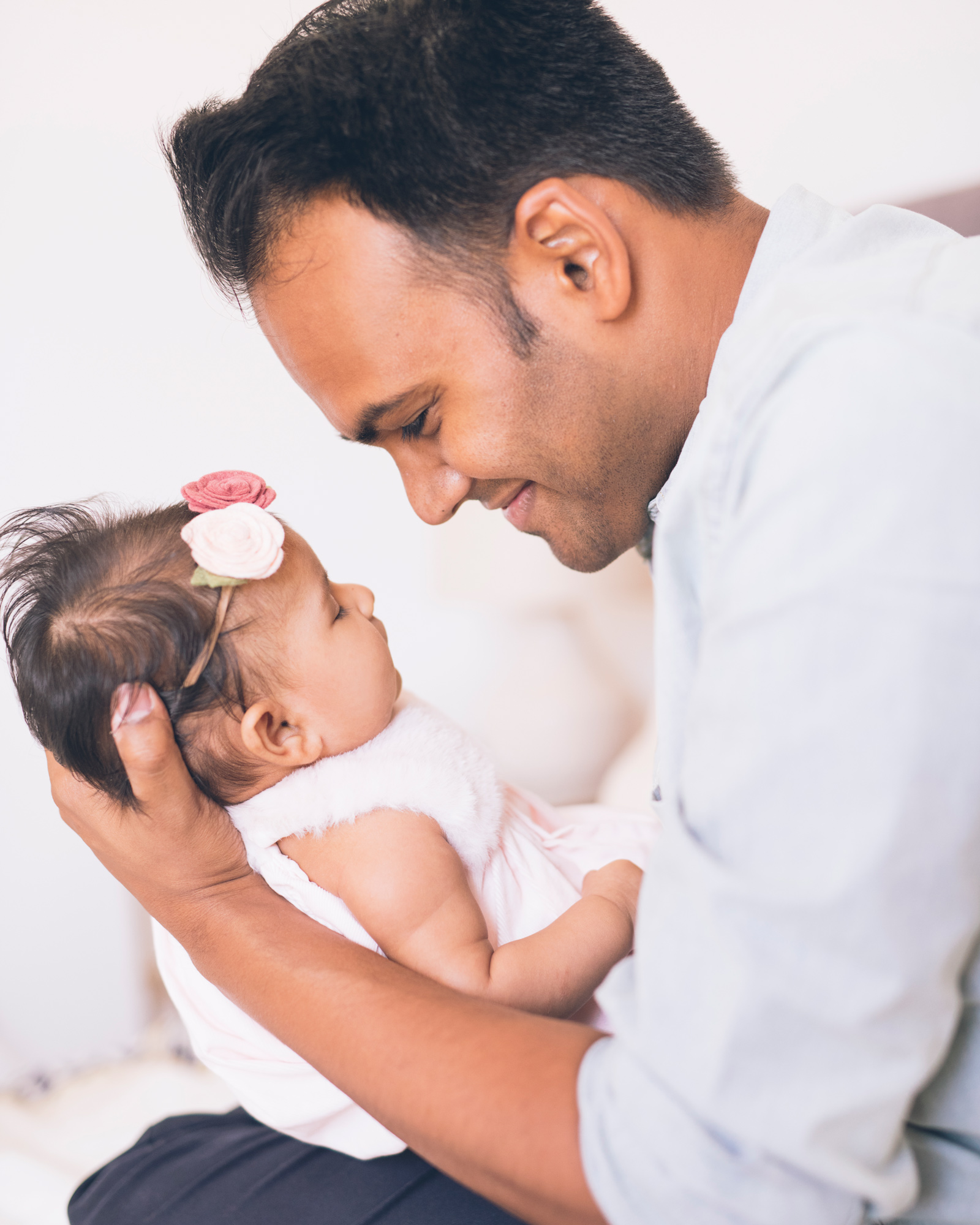 father-looking-lovingly-at-his-three-month-old-baby-girl-with-a-smile-.jpg