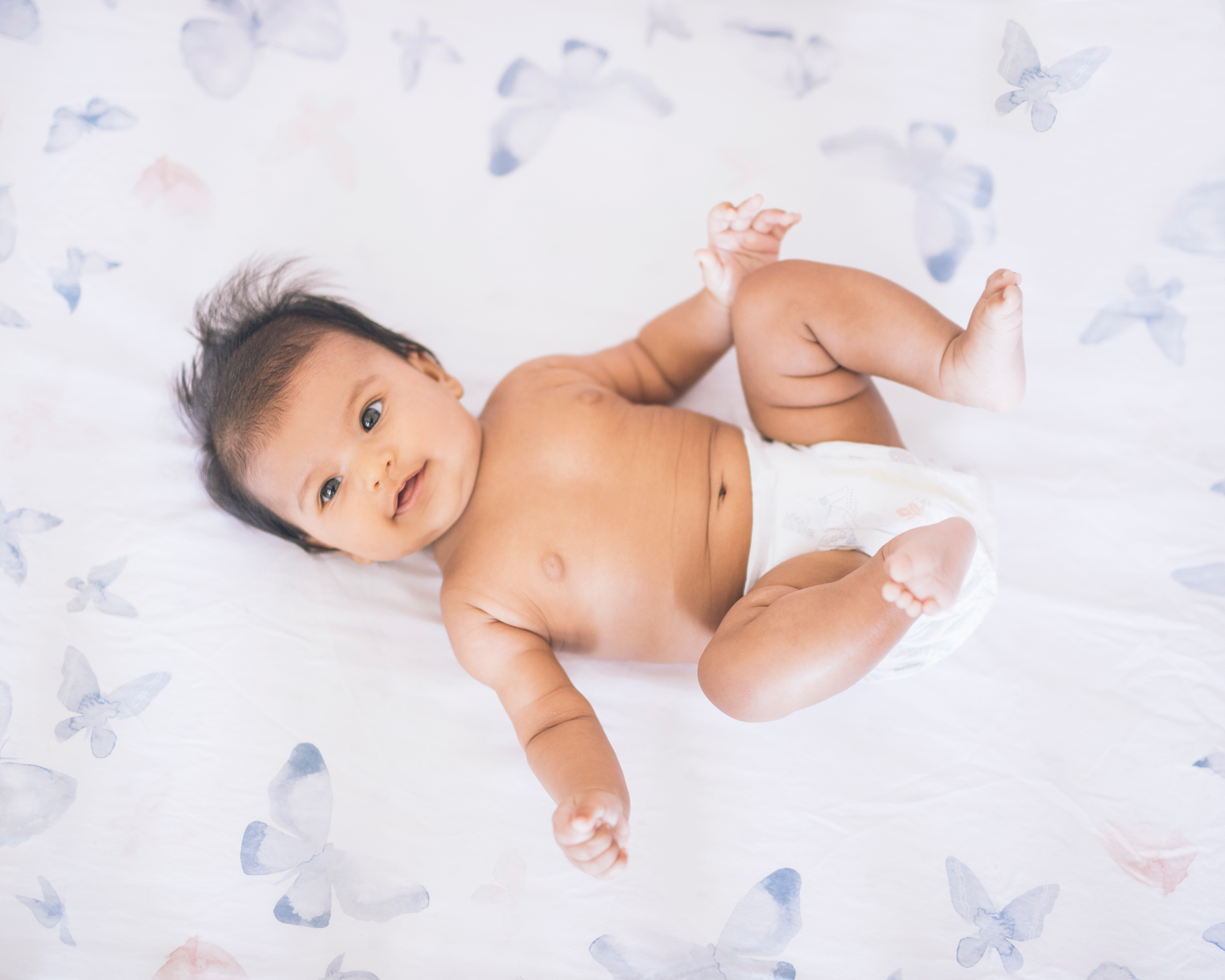 baby-girl-in-her-crib-with-butterflies.jpg