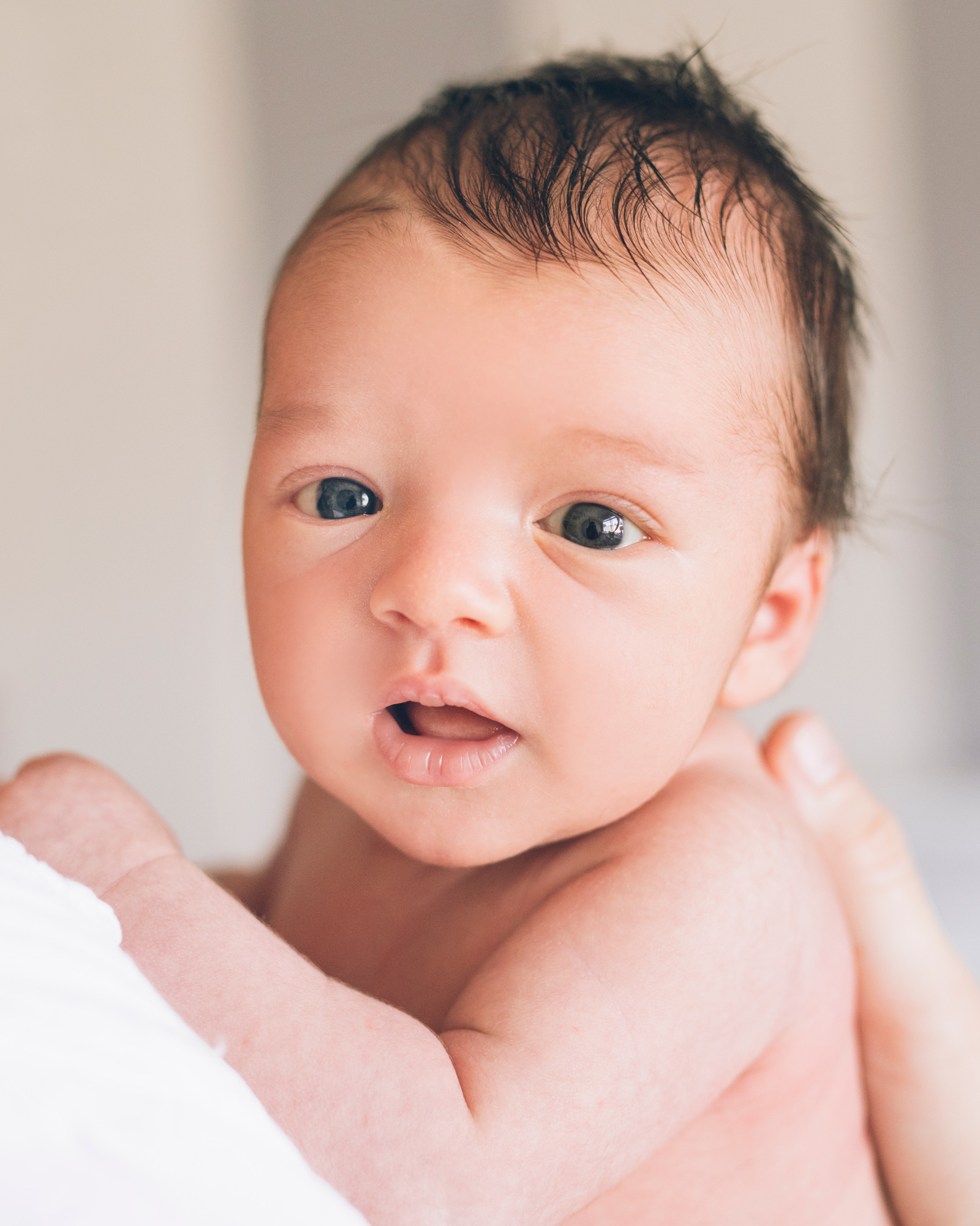 portrait-of-a-newborn-baby-boy-holding-his-head-up-and-looking-at-the-camera.jpg