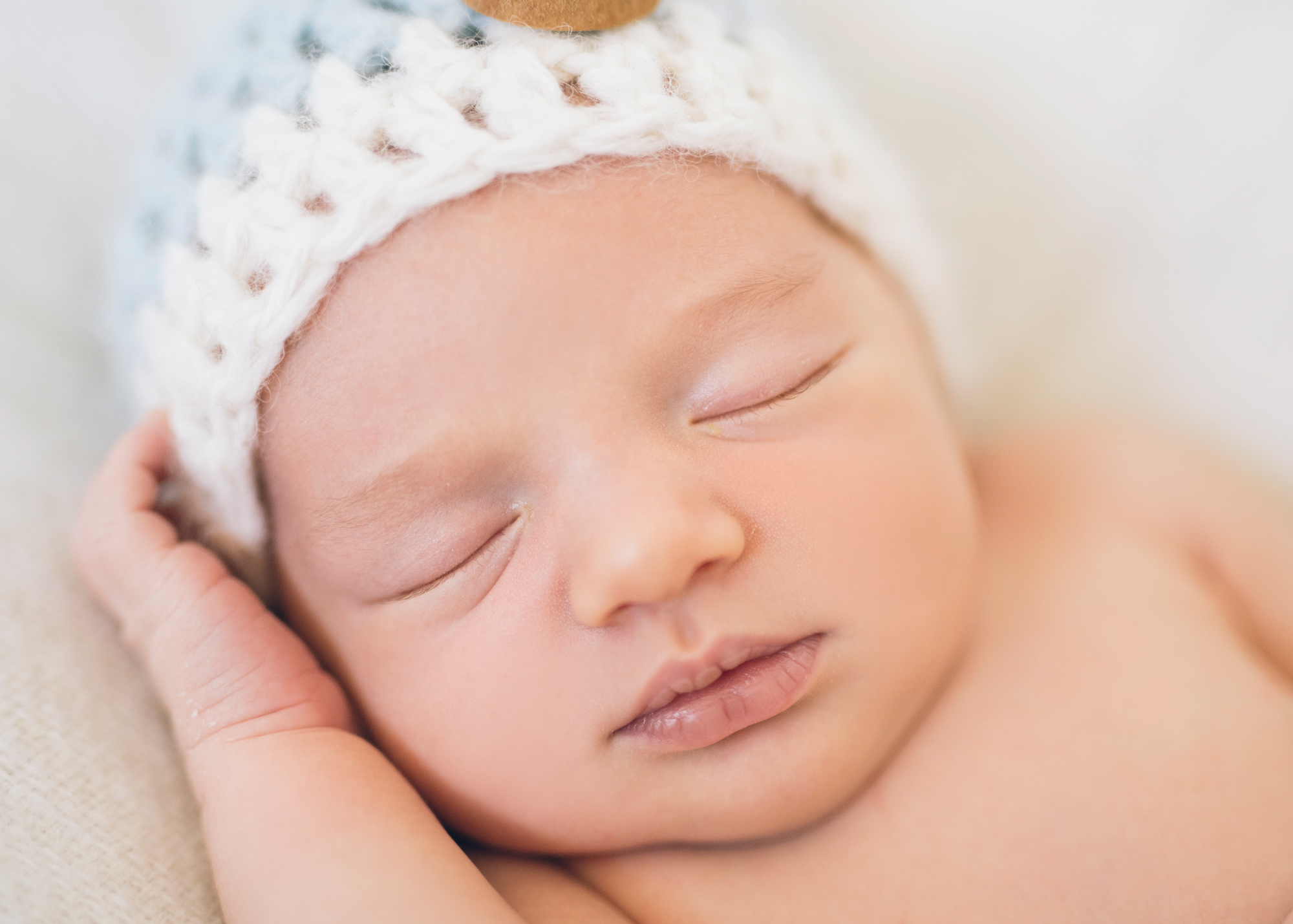 newborn-baby-boy's-wearing-a-hat-and-asleep.jpg