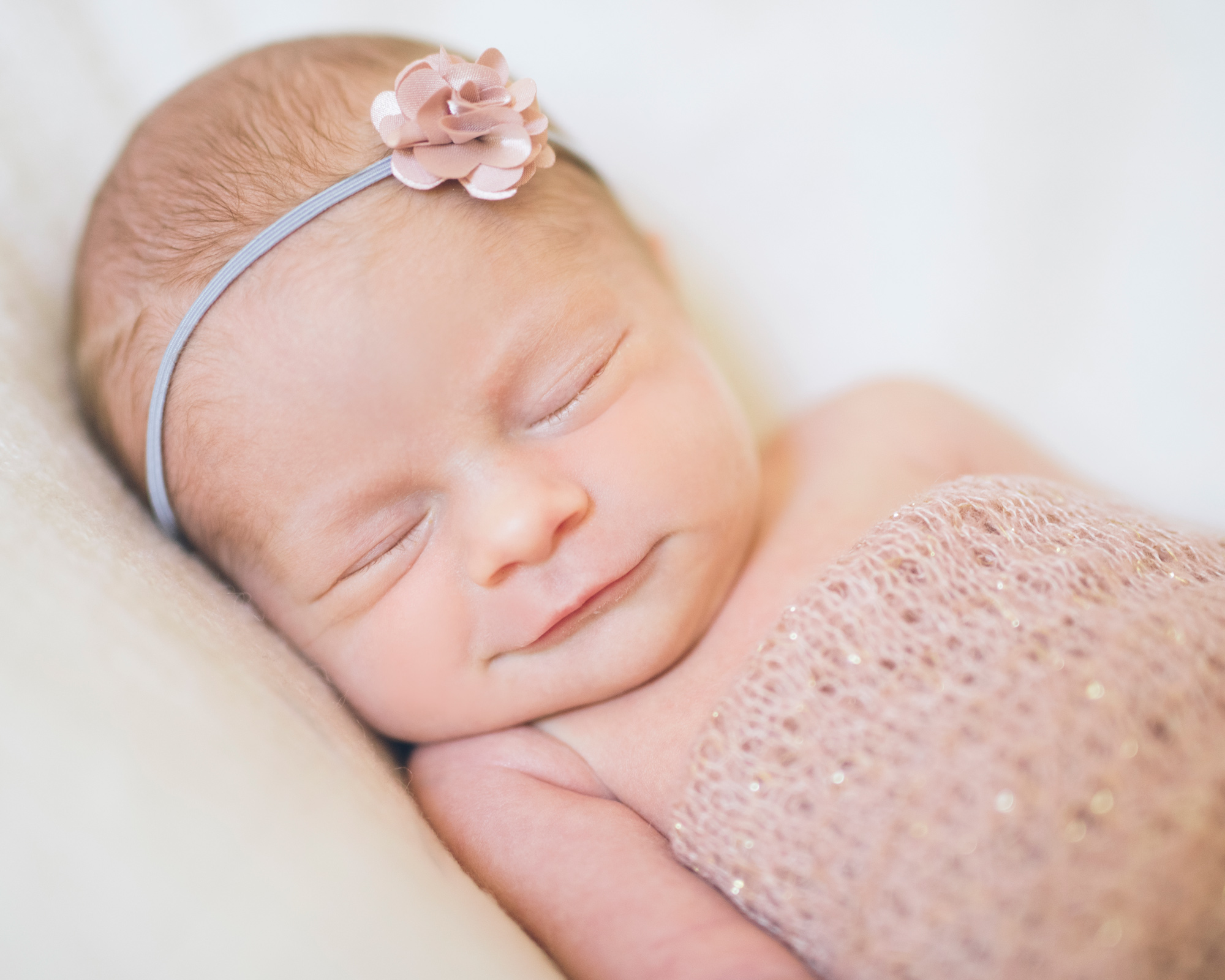 walnut-creek-newborn-photographer-captures-portrait-of-a-baby-girl-with-a-flower-headband.jpg