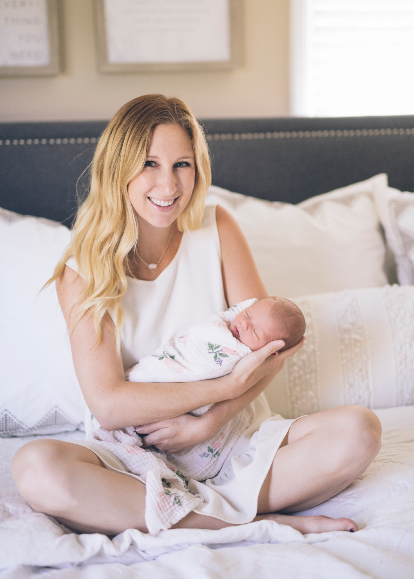 mother-sitting-on-the-bed-holding-her-baby-girl-in-walnut-creek.jpg