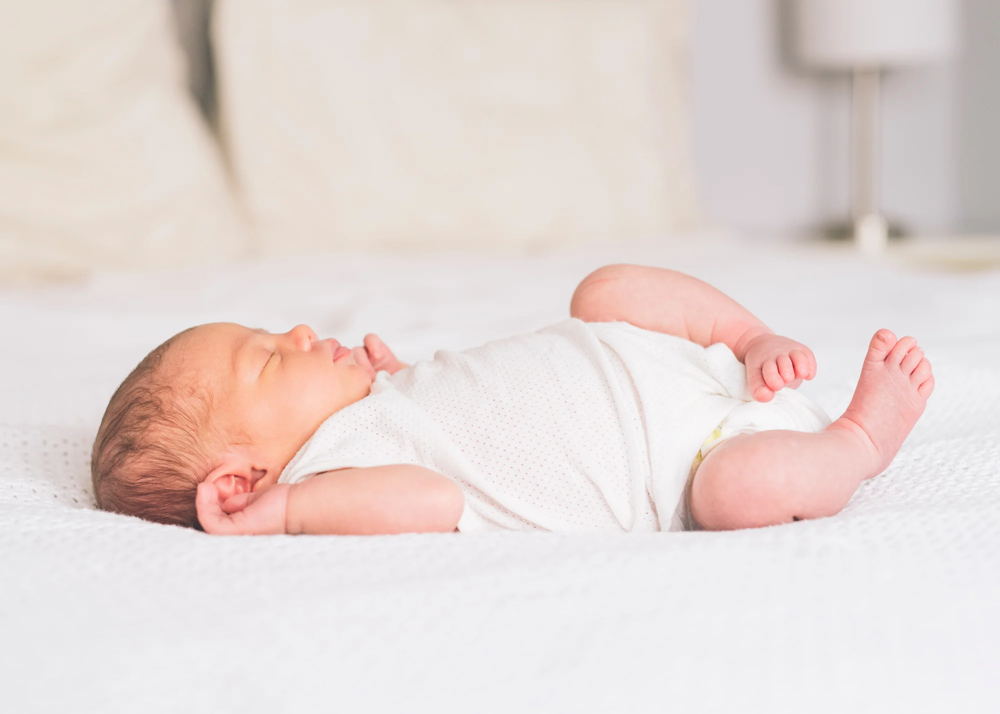 newborn-baby-asleep-on-the-bed.jpg