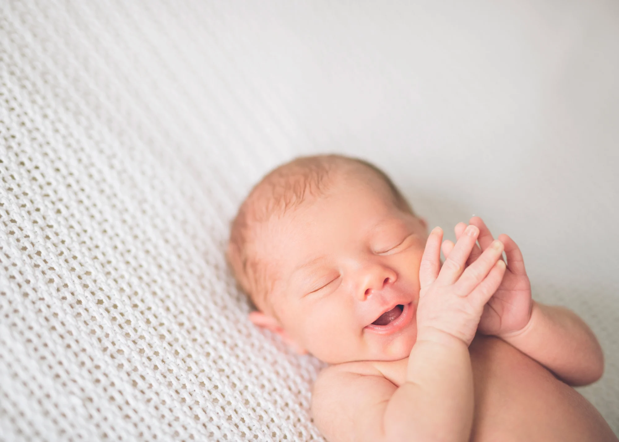 newborn-baby-girl-sleeping-on-white-blanket.jpg