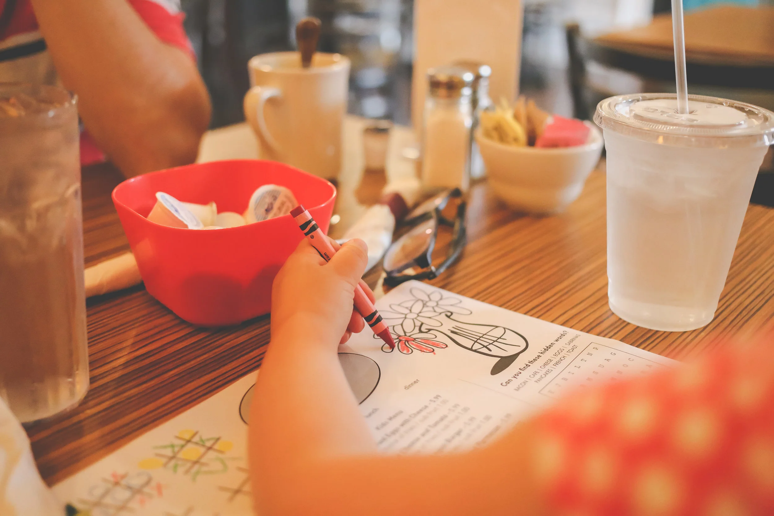 Coloring while waiting for our food at Sabrina's Cafe, Philadelphia, PA. Documentary Family Photography.