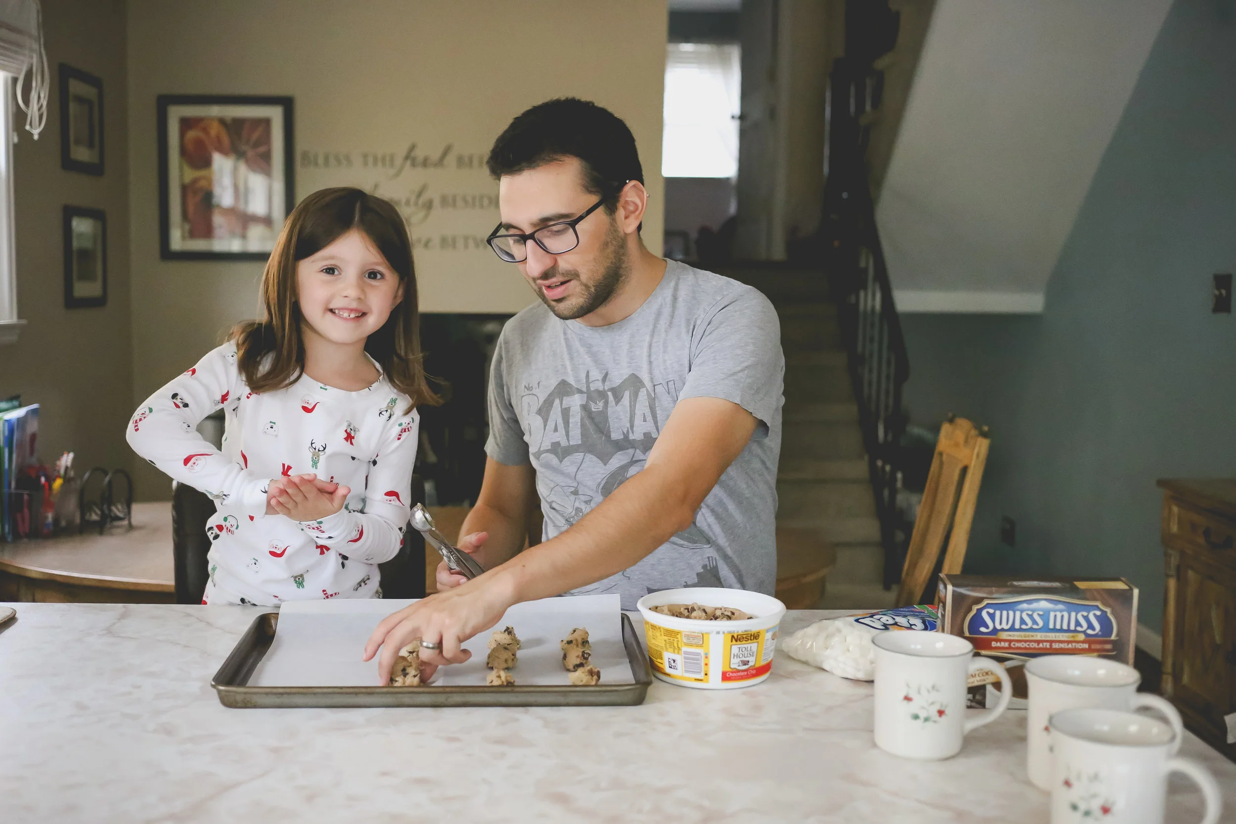 Smiling while baking Christmas cookies, holiday sessions by Jen Grima Photography, Family Photojournalism.