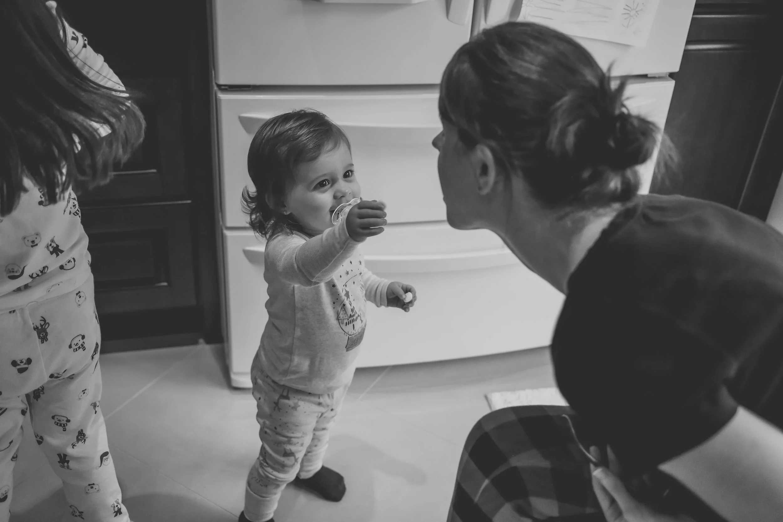 Baby girl feeding marshmallows to mom, Staten Island Family Photography holiday session.