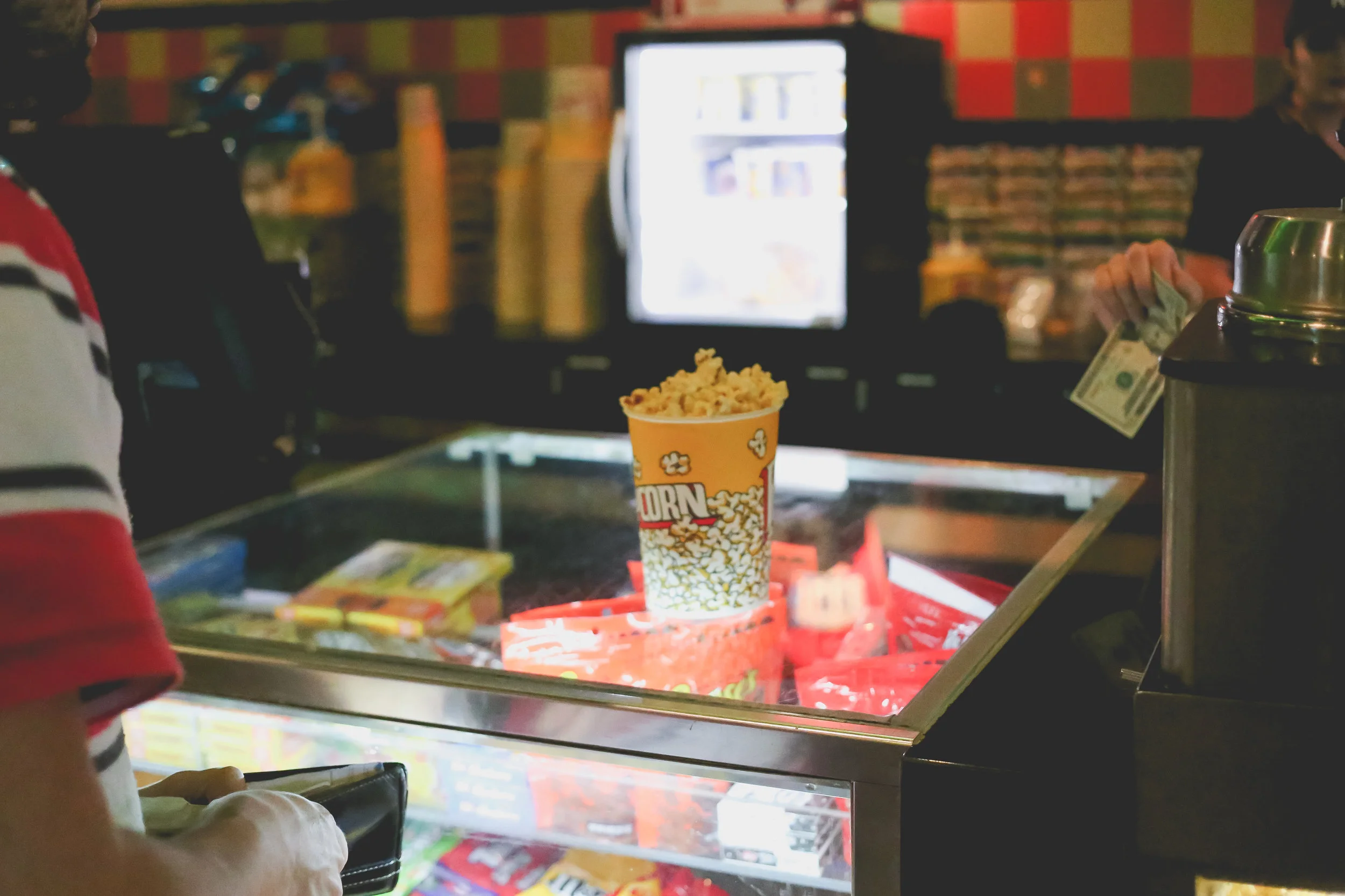 Buying popcorn at The Atrium movie theater in Staten Island, NY. Family Photojournalism.