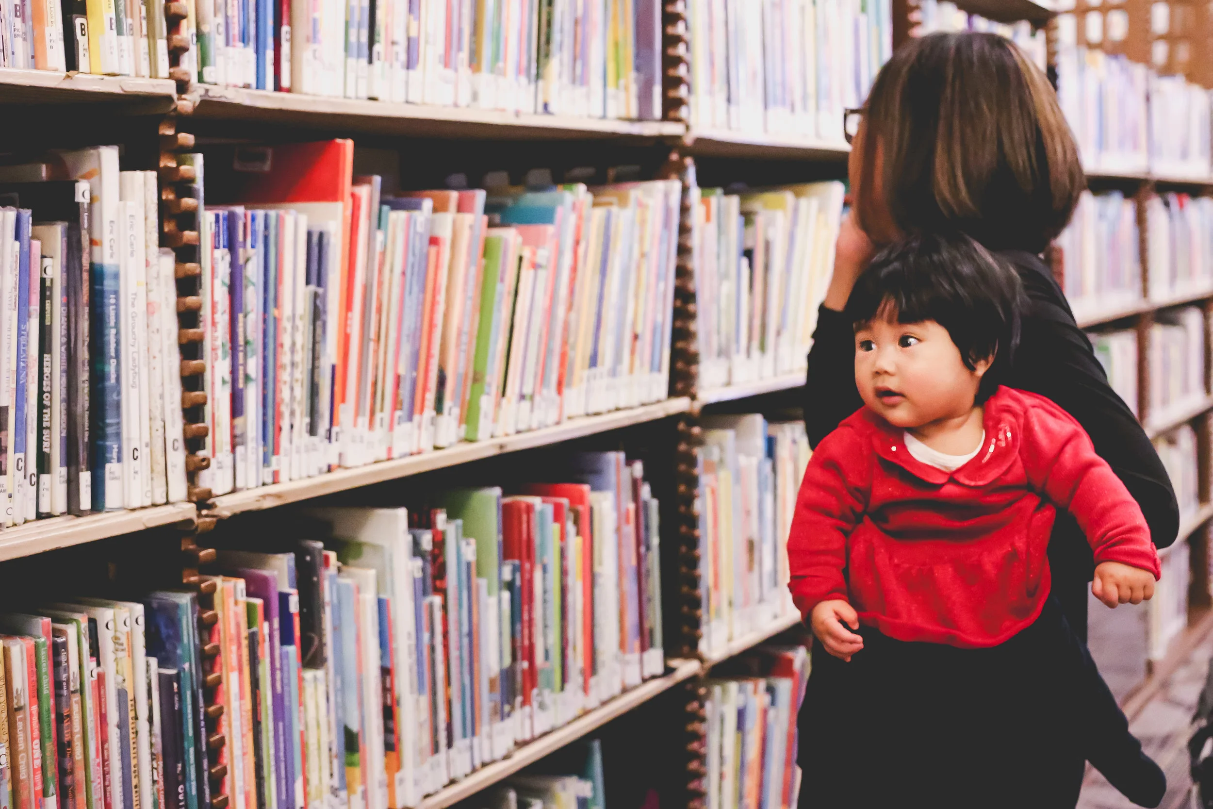 Baby looking at books with mom at the 42nd Street branch of the New York Public Library. Family Photography session with Jen Grima, Lehigh Valley Photographer.