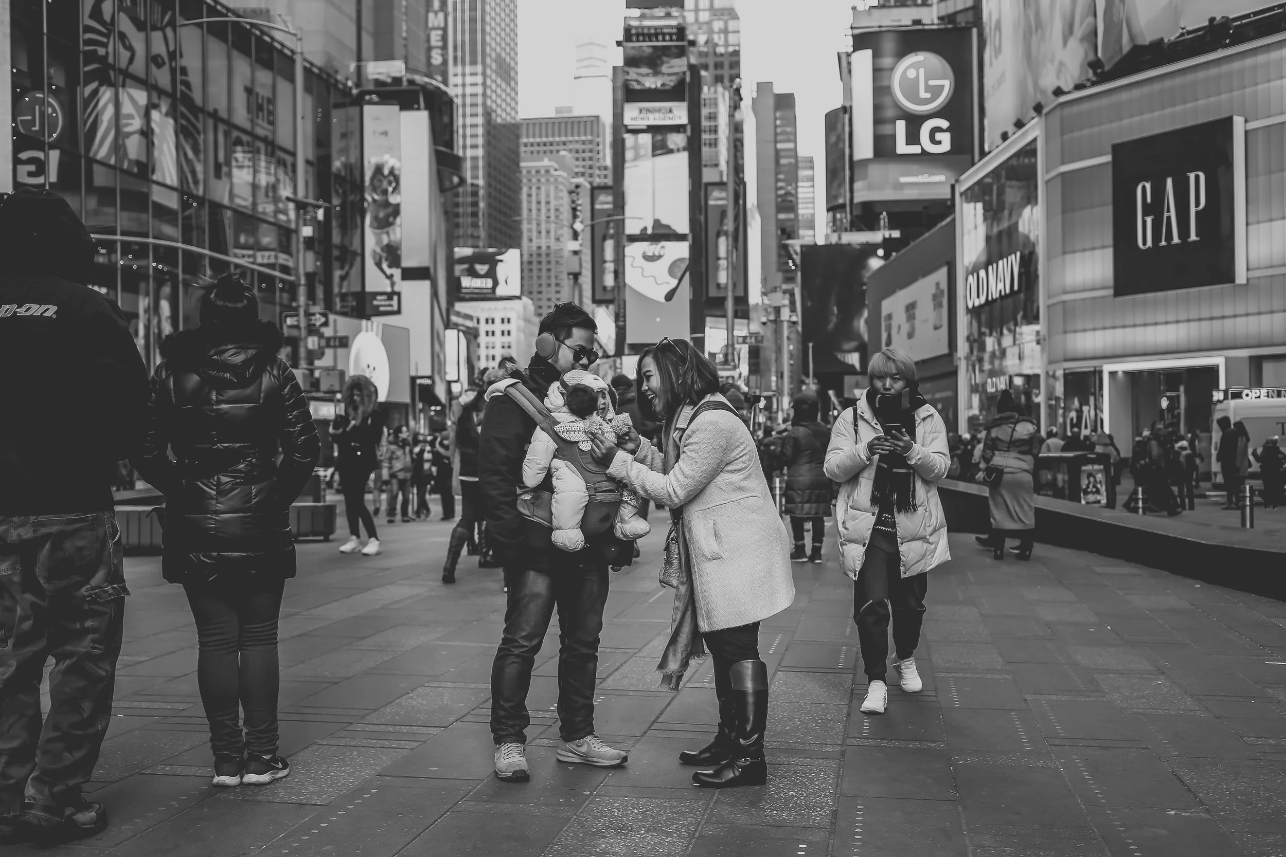 A mother tending to her baby in Times Square, New York City. Photo taken by Jen Grima, New York City vacation photographer.