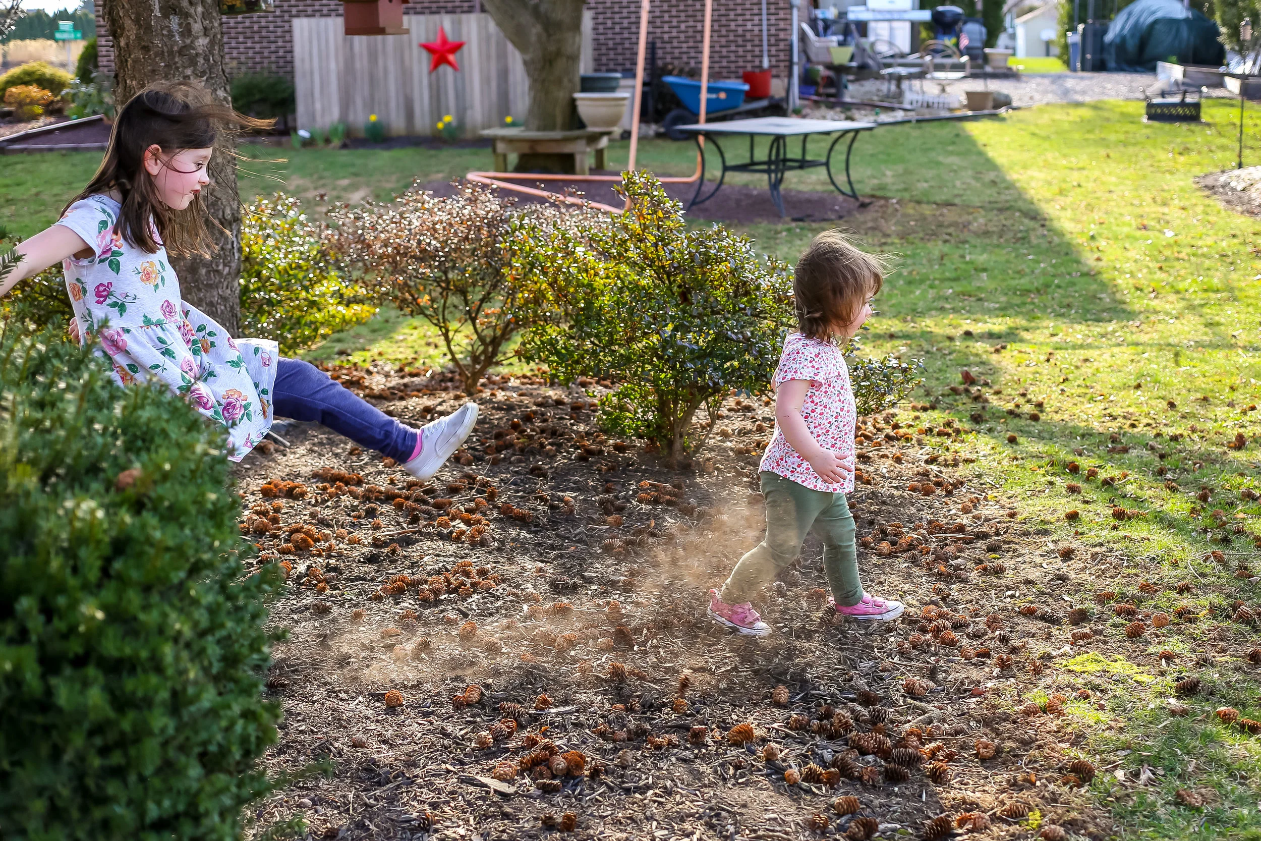 Young girl kicking the dirt during a family photo session in Lehigh Valley, PA.
