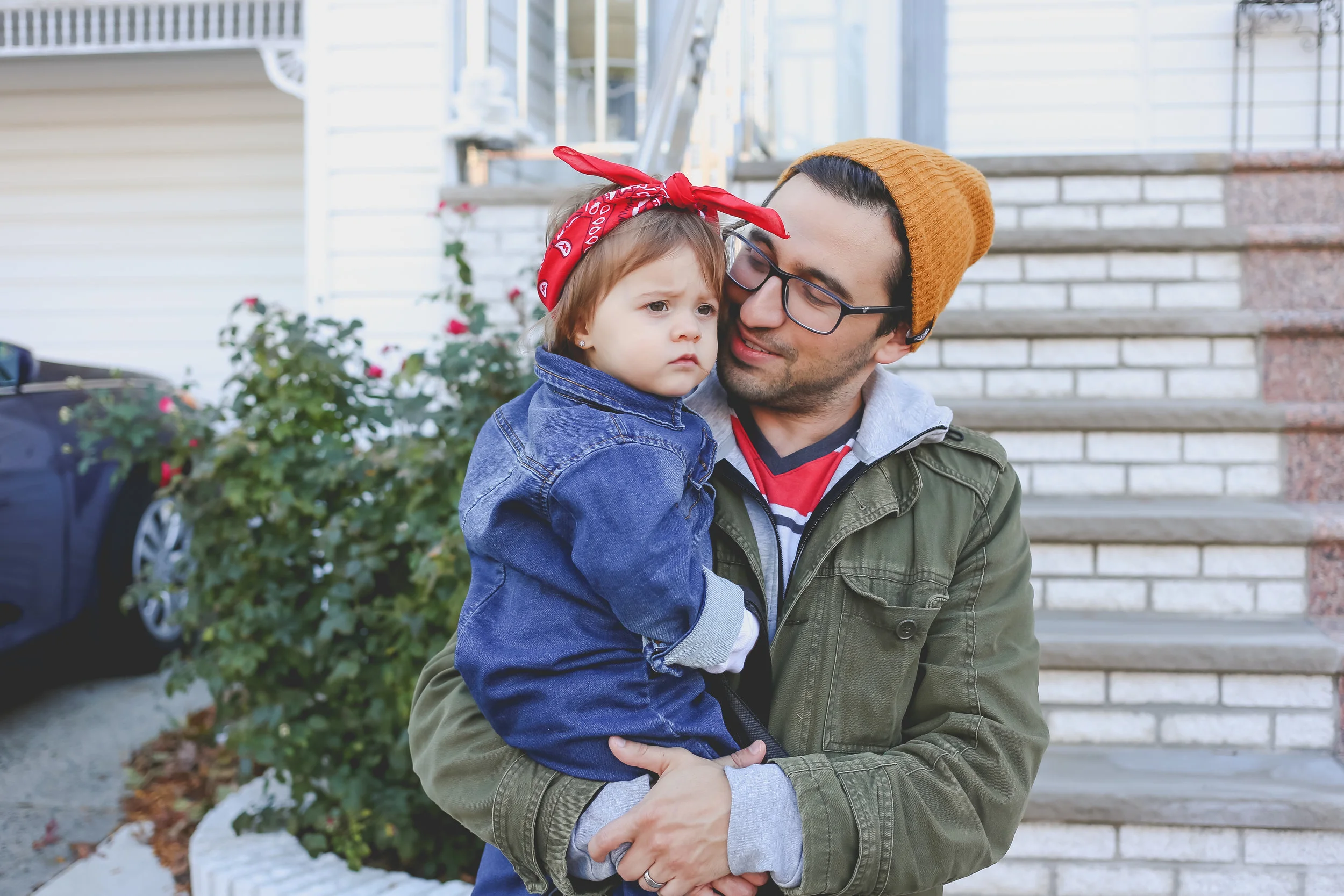 Father with his toddler daughter, dressed as Rosie the Riveter on Halloween.