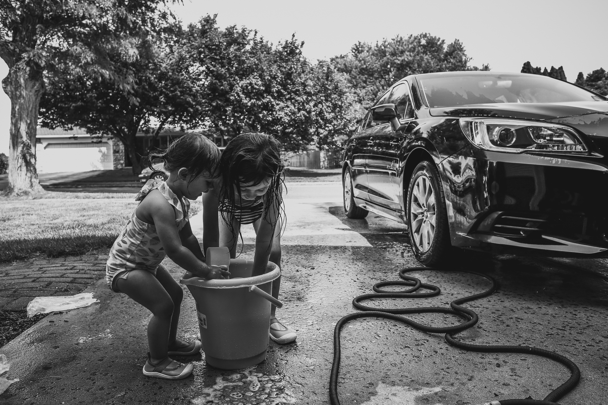  Girls washing the car during an outdoor at home summer session in Lehigh Valley, PA. 