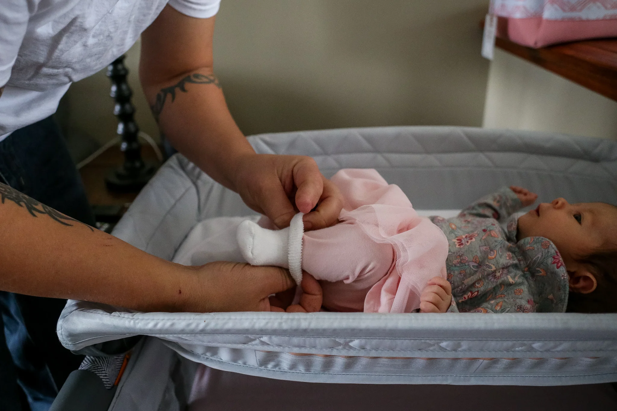 Dad putting on his newborn daughter’s socks in Quakertown, PA.