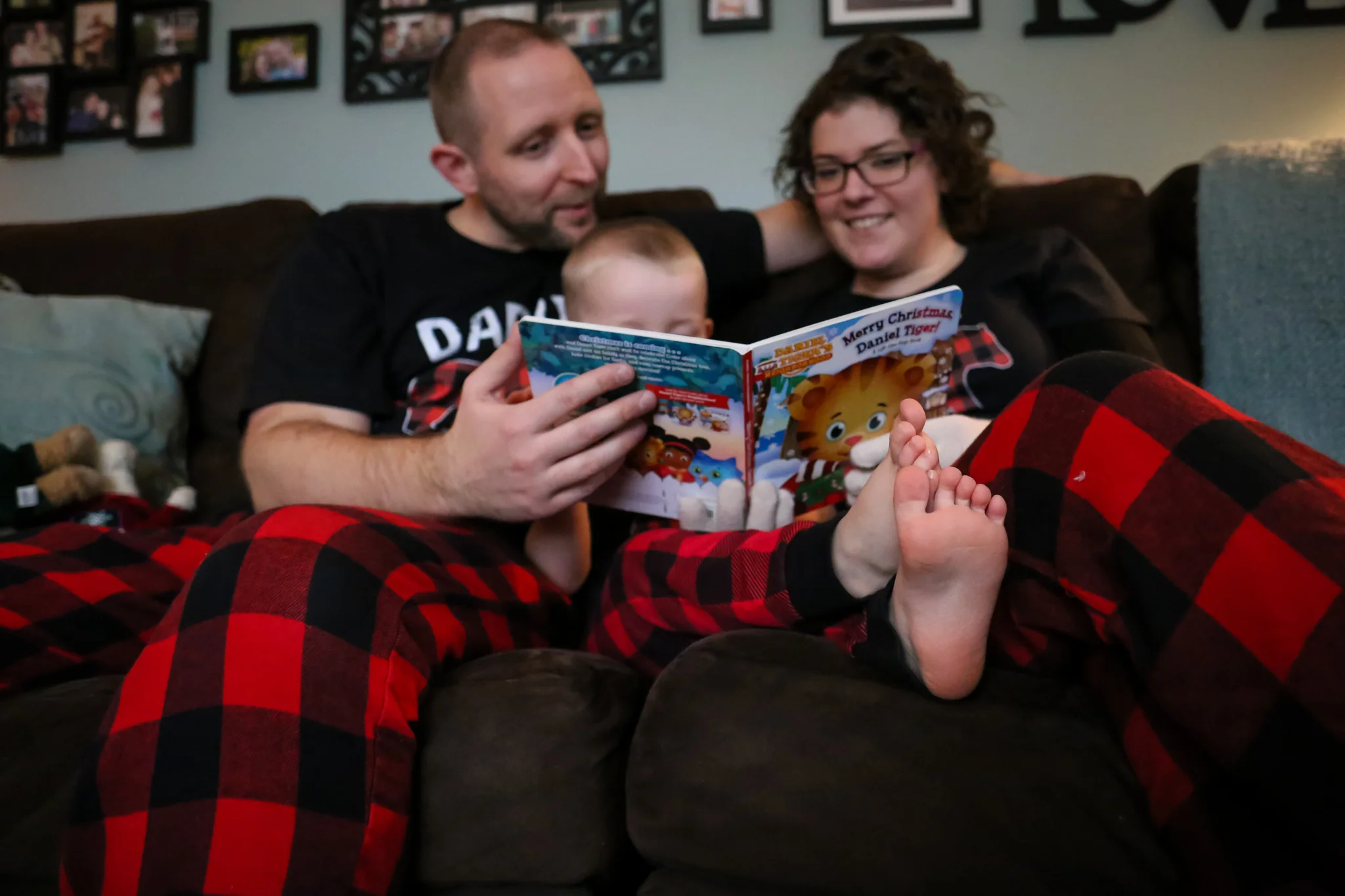 Documenting holiday traditions - a young family reads a Christmas story together in their Emmaus, PA home.