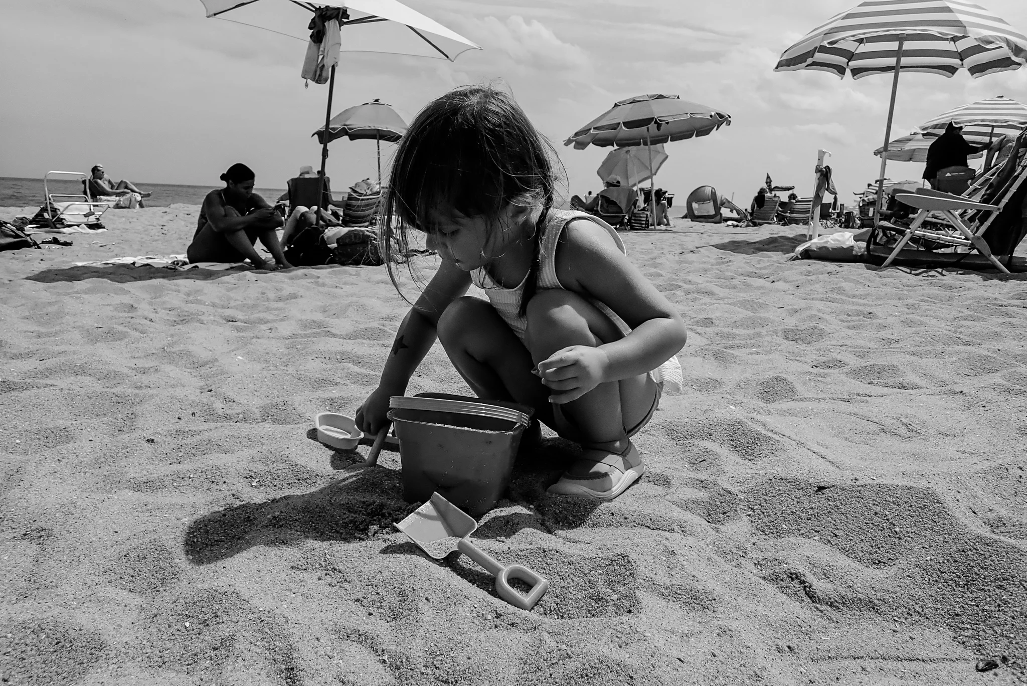 Toddler playing in the sand at the beach during a family vacation in Asbury Park, NJ.