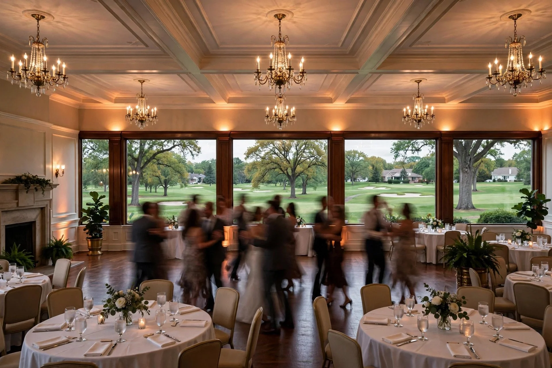 Elegant wedding reception inside a classic country club ballroom in Hinsdale, Illinois, with chandeliers, white linens, golf course views and guests dancing
