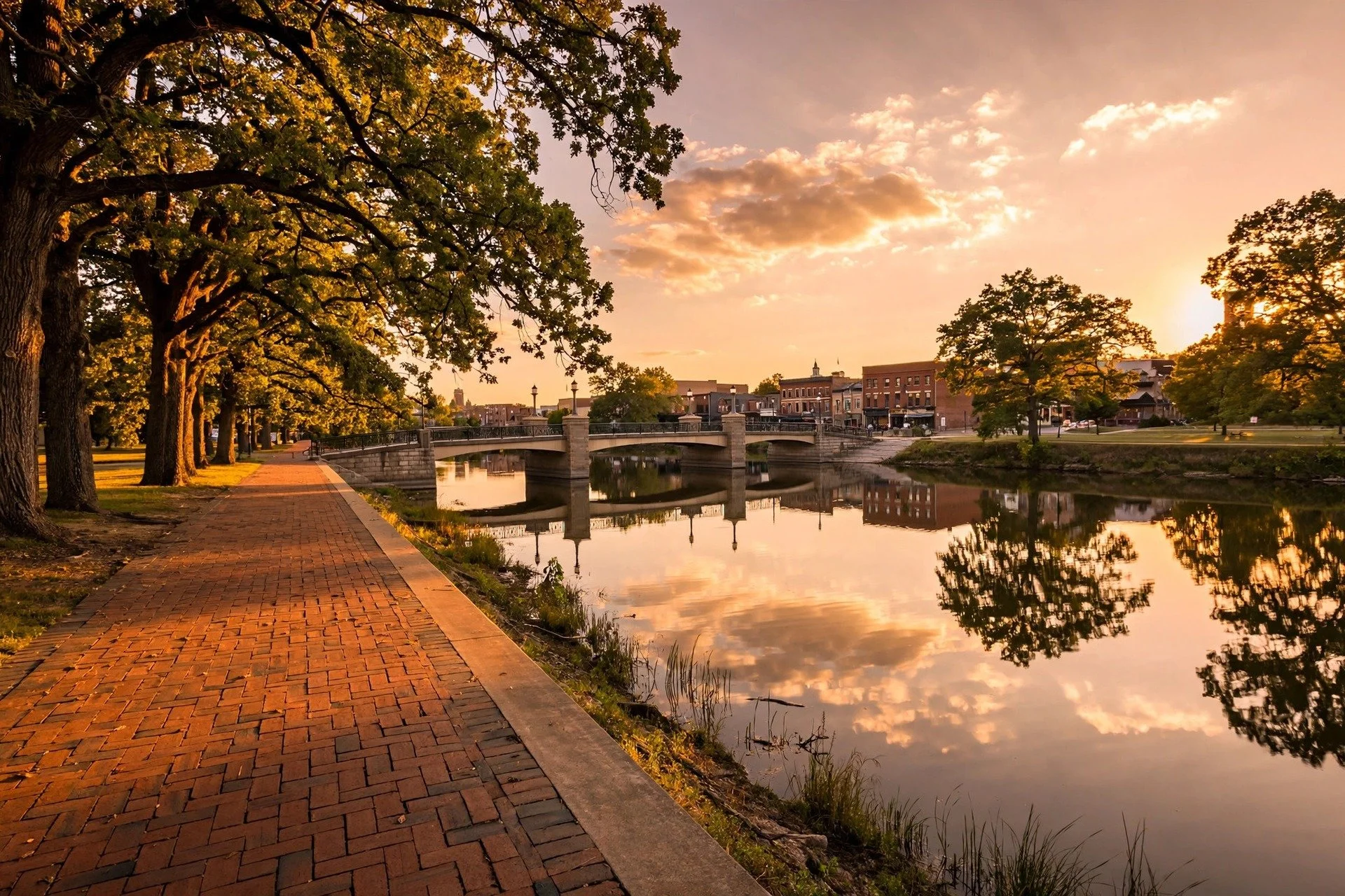 Sunset over the Fox River riverwalk and bridge in downtown St. Charles, Illinois