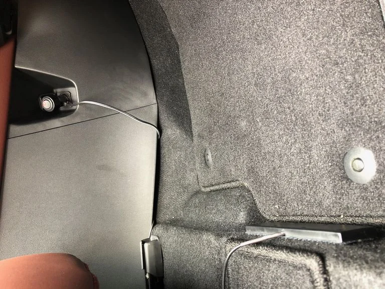 The quick install: Power cord (mostly) tucked out of sight, booster under seat, inside antenna at the back of the footwell.