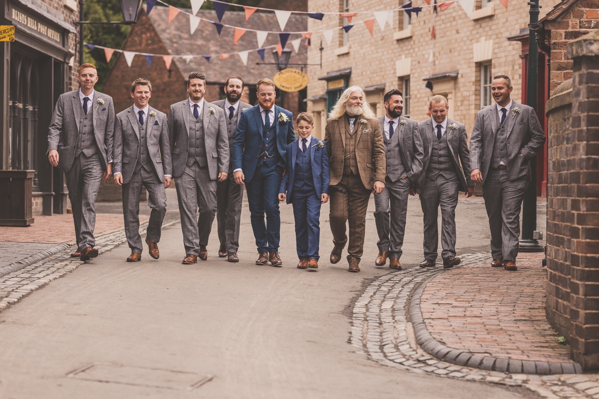 groom and groomsmen walking down a vintage street at Blists Hill Victorian Town, Ironbridge