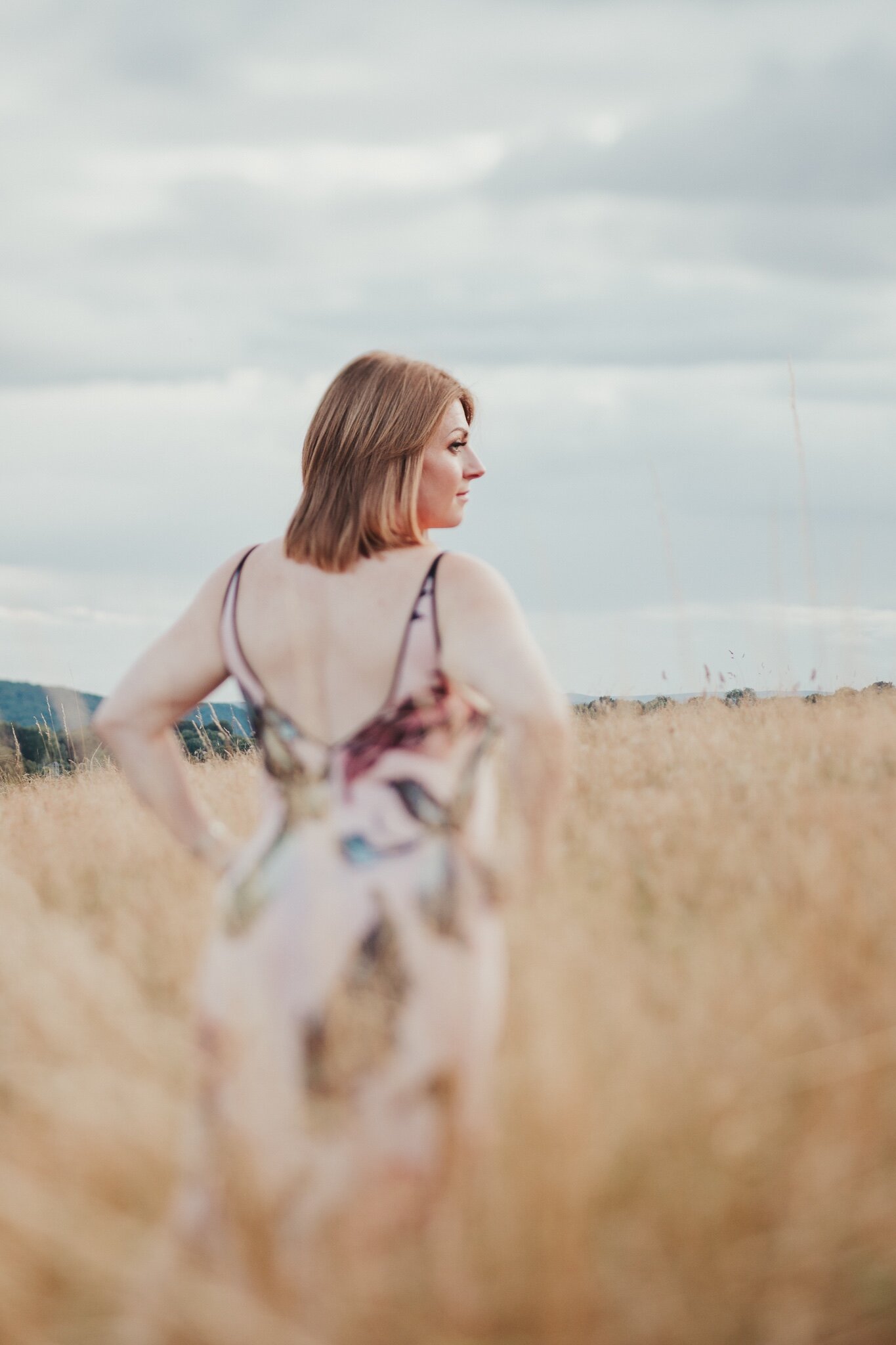 Woman posing in a field during an outdoor boudoir photo shoot in Shropshire