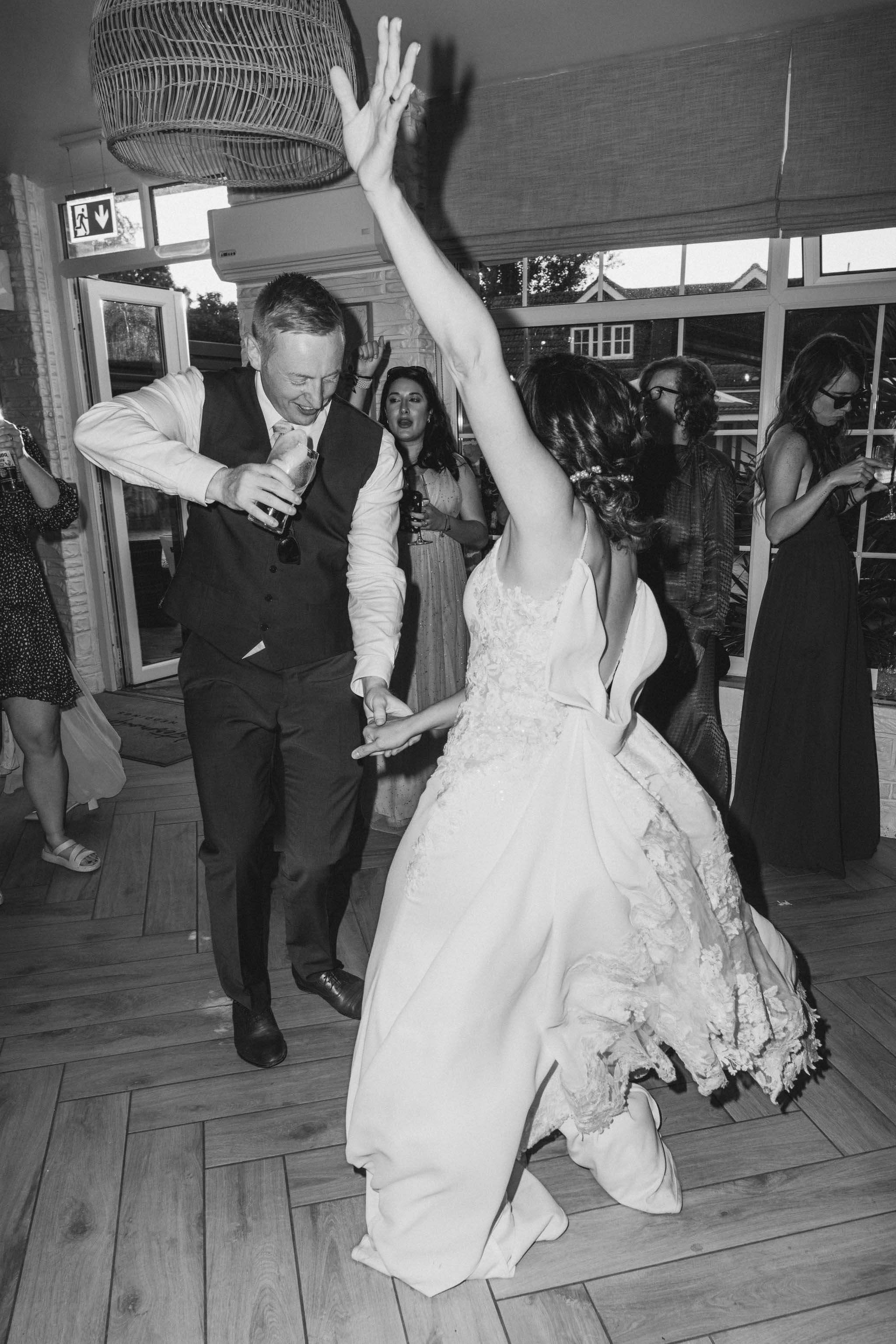 Bride dancing with a wedding guest at Watermouth Cove Weddings