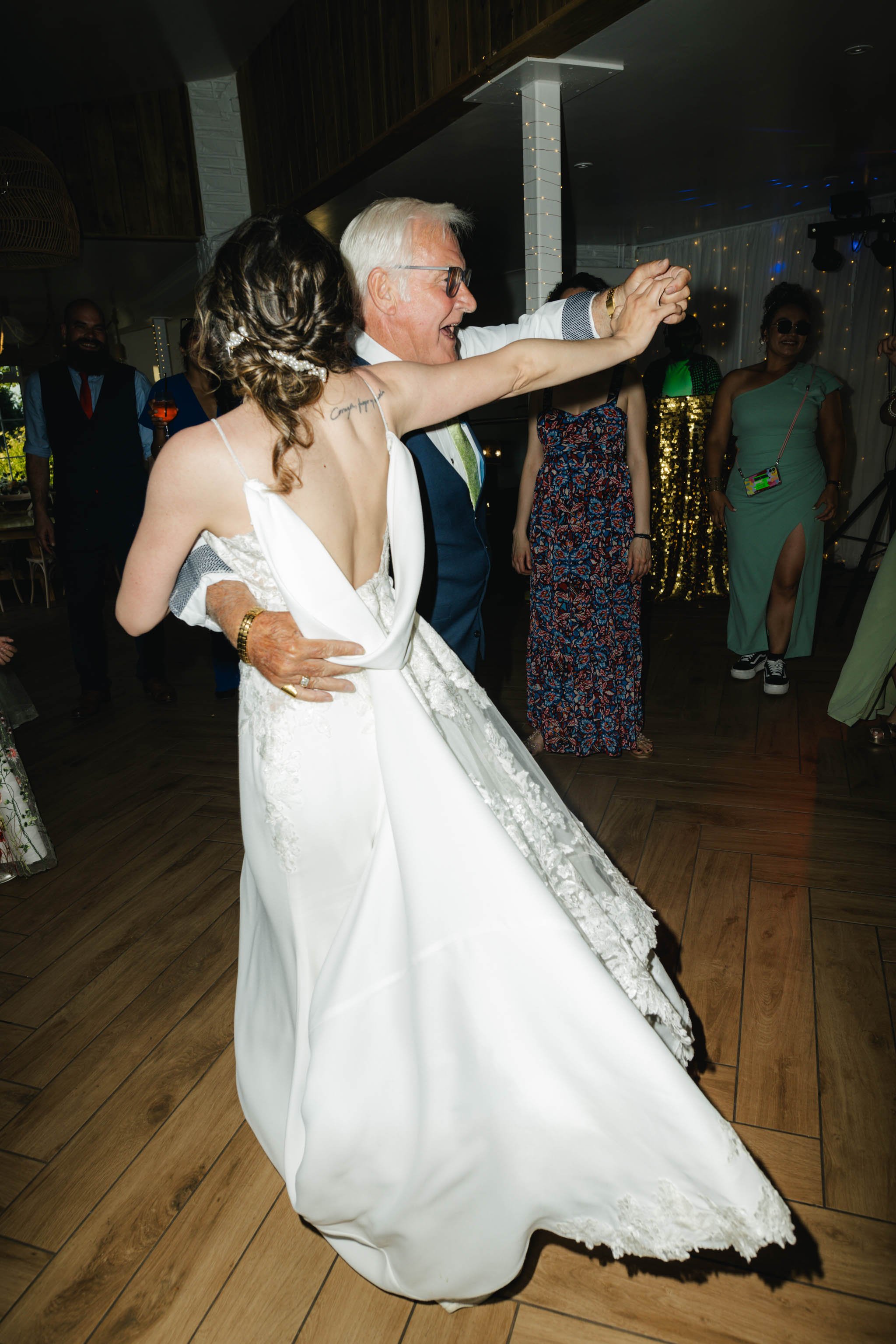 Bride dancing with a wedding guest at Watermouth Cove