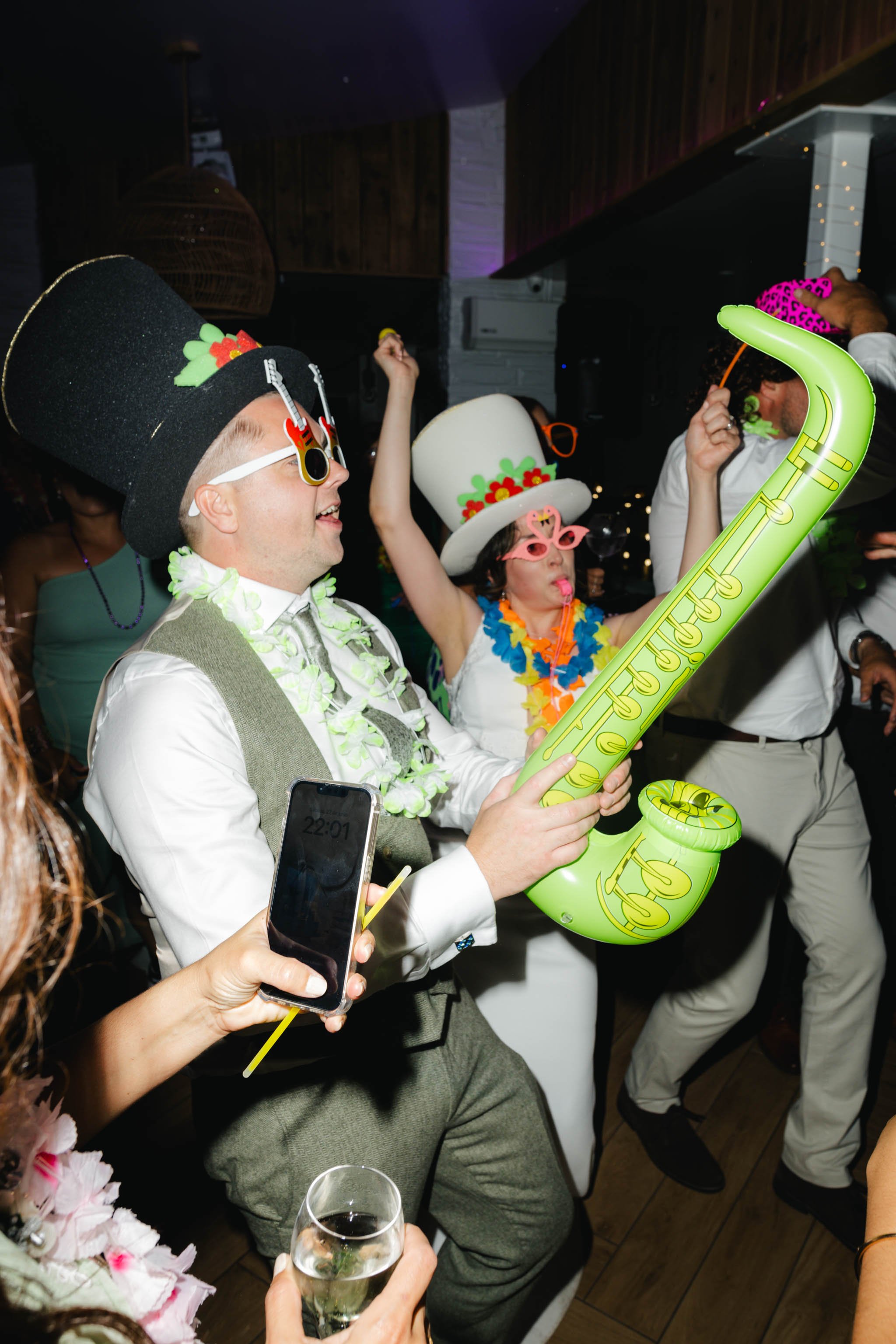 Bride and groom with inflatable props on the dance floor at Watermouth Cove Weddings
