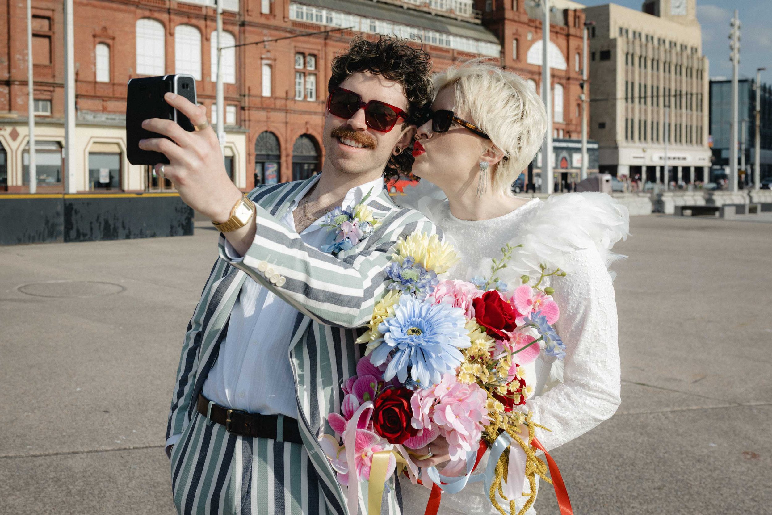 Couple taking a selfie at their seaside elopement in Blackpool