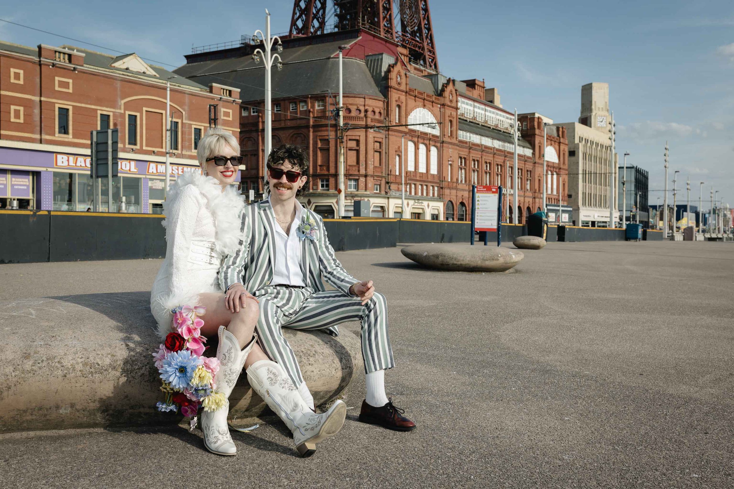 Modern couple in front of Blackpool tower during their intimate elopement